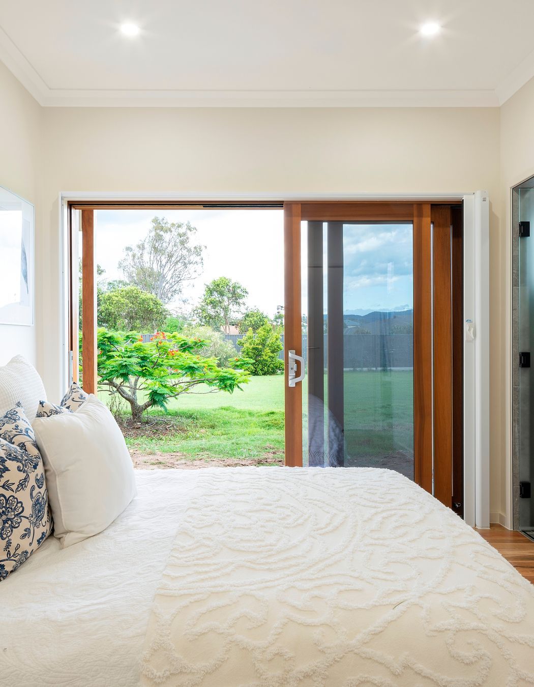 The bedroom is designed to allow a bedbound person to still experience a visual connection to the land. It is protected from western sun while still welcoming a generous winter warming.  Photo:®Angus Martin