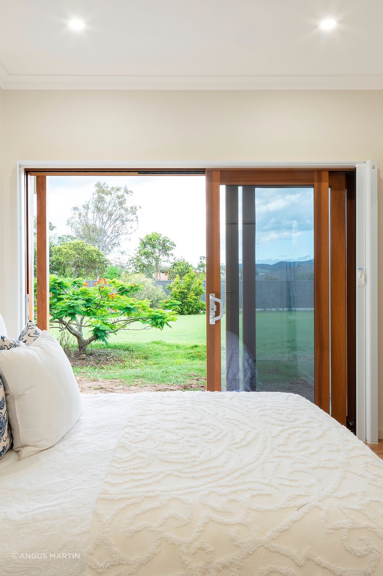 The bedroom is designed to allow a bedbound person to still experience a visual connection to the land. It is protected from western sun while still welcoming a generous winter warming. Photo:®Angus Martin