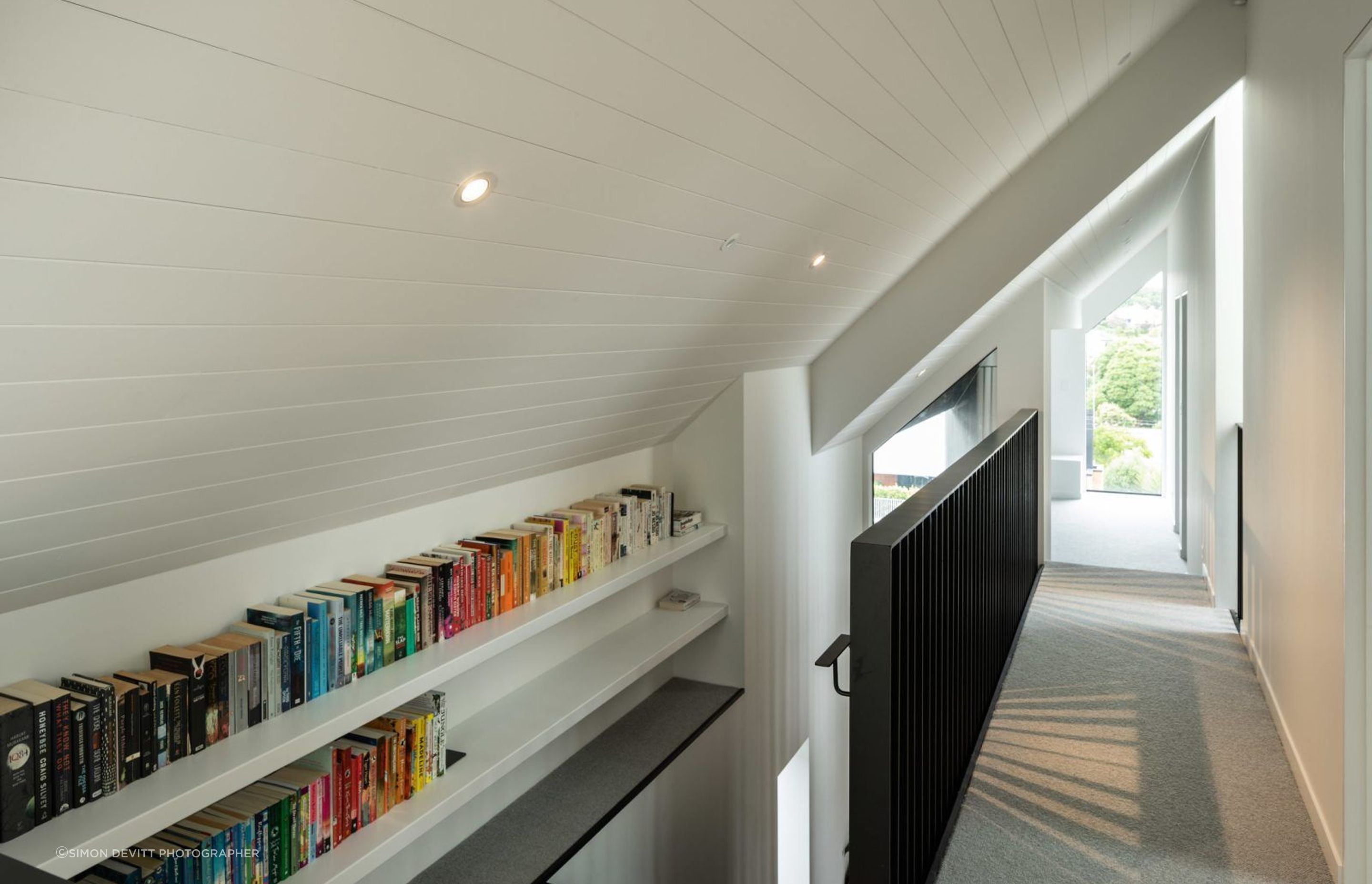 Upstairs space is maximised by tucking the hallway into the slant of the gabled roof.