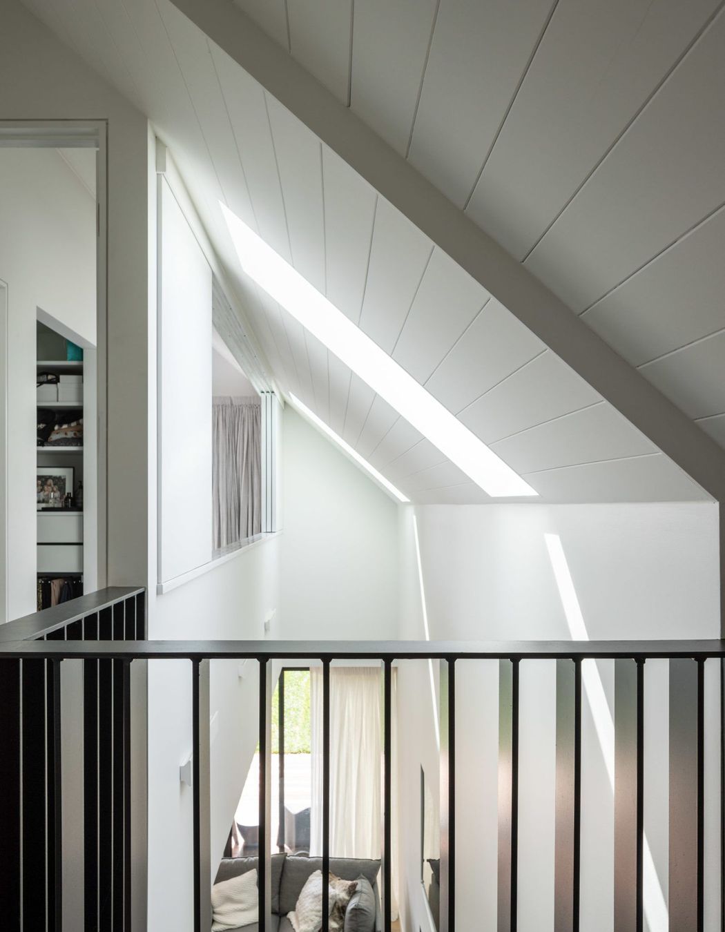 The void is designed to create light and the feeling of spaciousness in the living spaces.