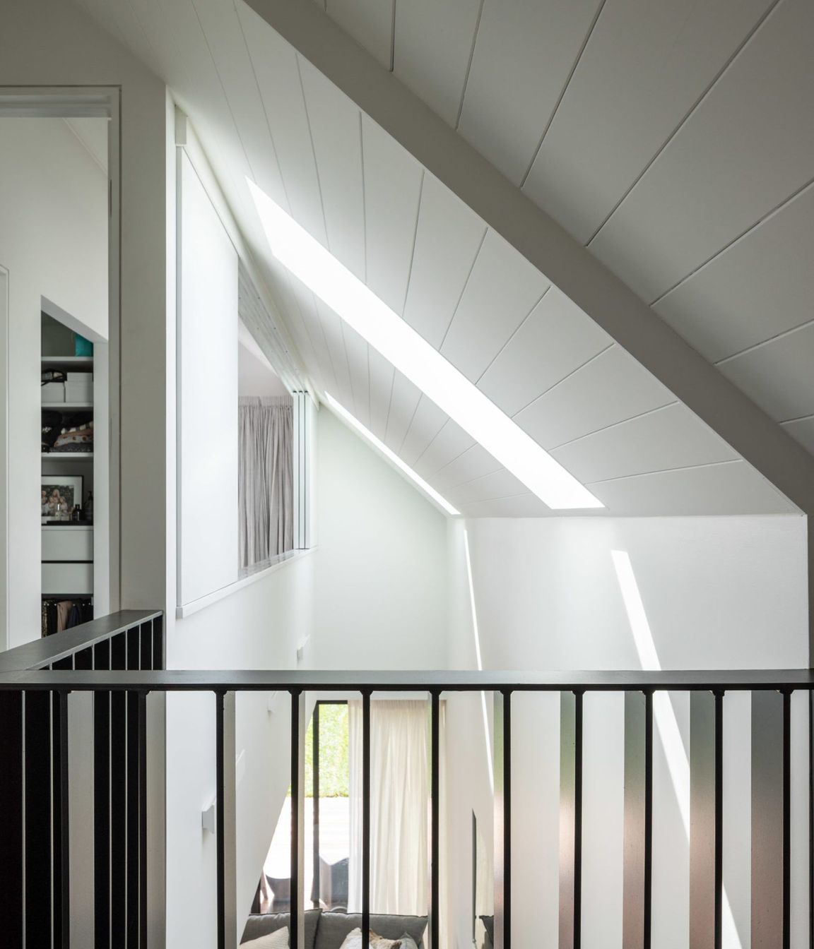 The void is designed to create light and the feeling of spaciousness in the living spaces.