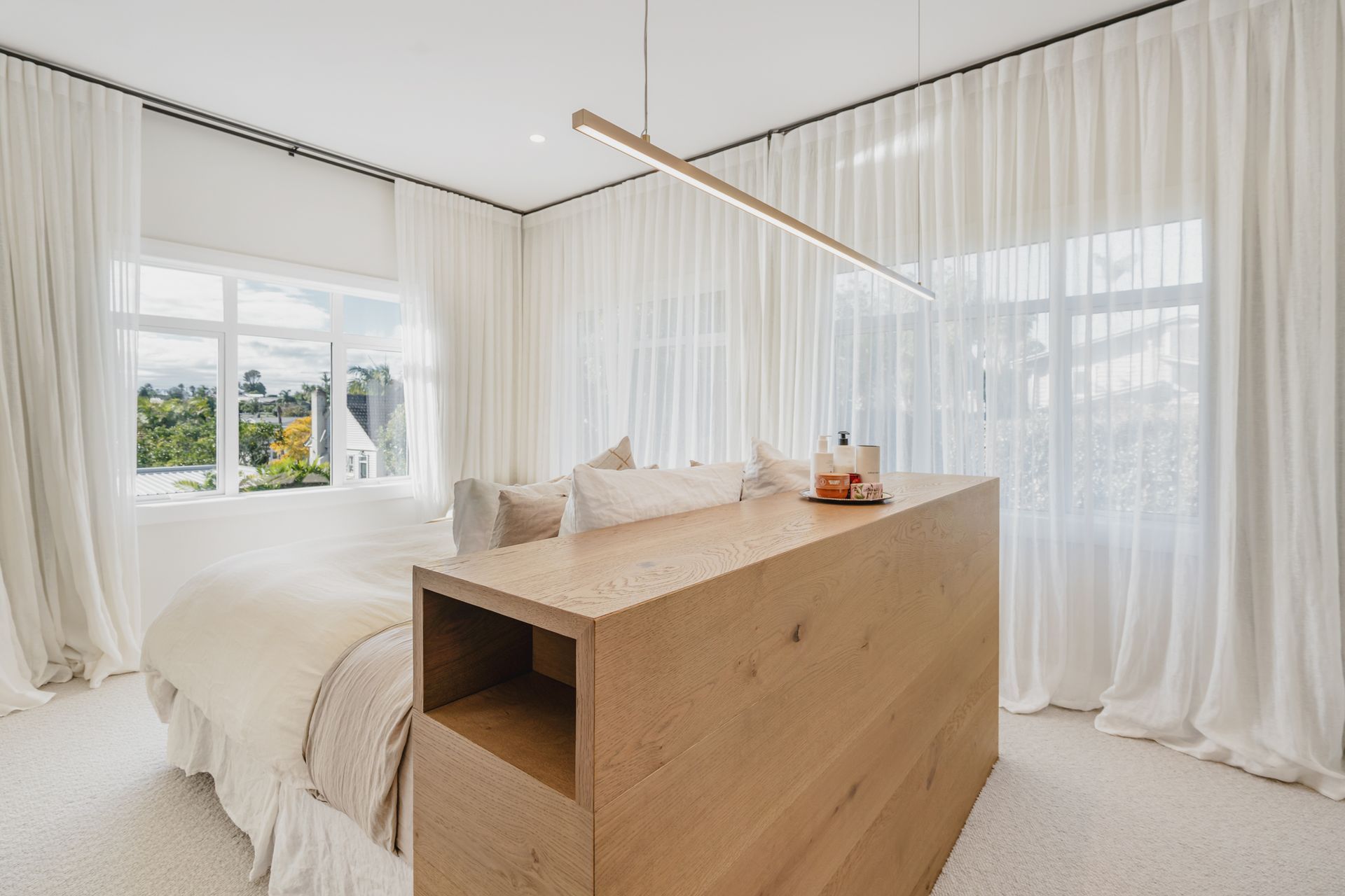 Westmere Bungalow | New-Build Residence | Internal view of master suite, designed like boutique hotel, the master suite offers a centralised bespoke wooden bed, walk in wardrobe and ensuite.