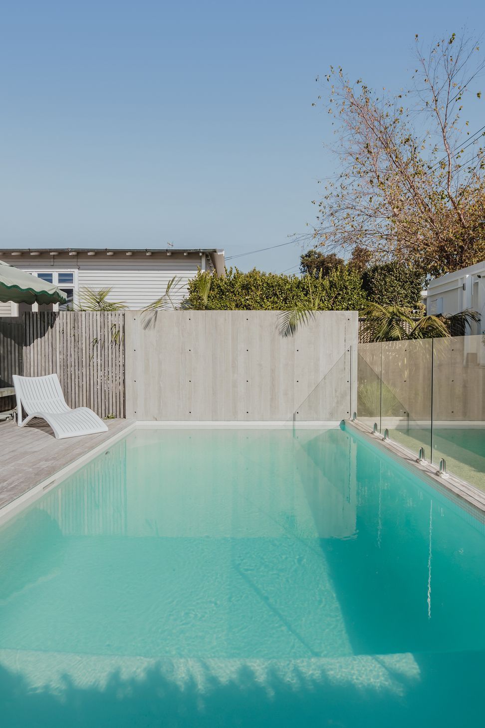 Westmere House | New-Build Residence | Concrete salt water swimming pool and in situ concrete fence in north facing aspect.