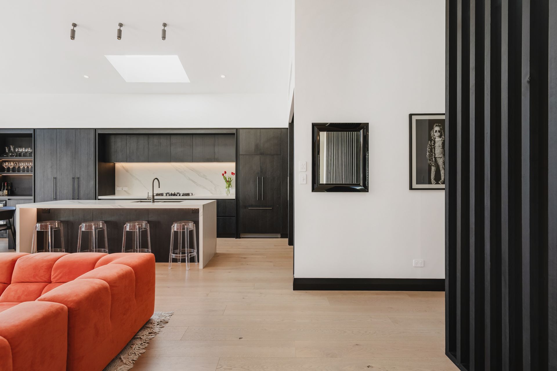 Westmere Bungalow | New-Build Residence | Internal view of new bespoke dark wood kitchen marble island and splashback. High stud vaulted ceiling and carefully placed sky lights.