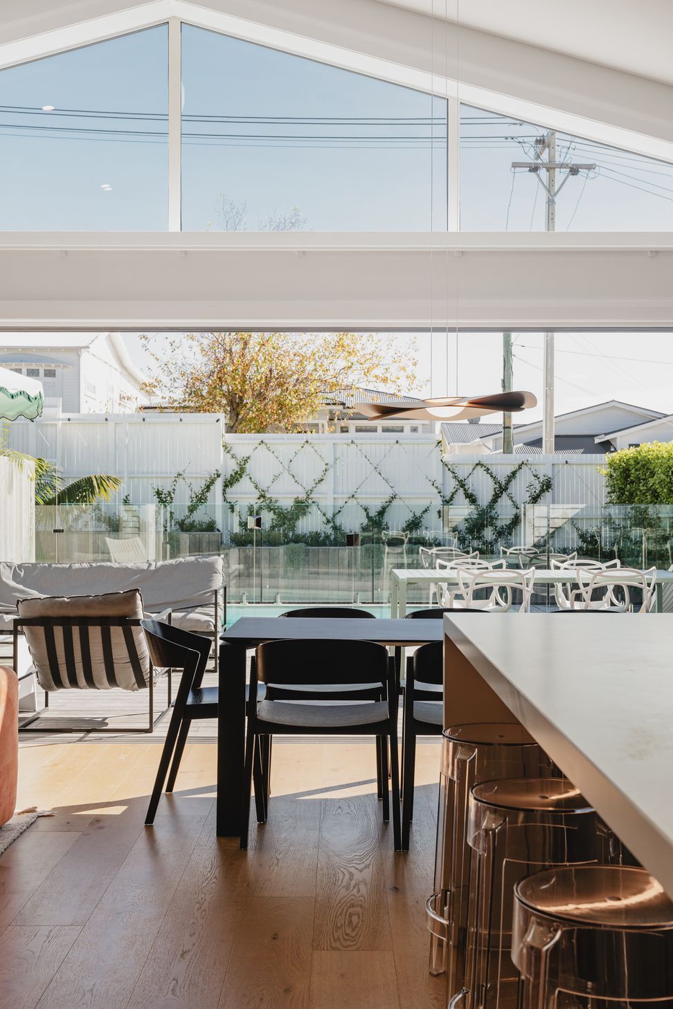 Westmere Bungalow | New-Build Residence | Internal view of open plan kitchen, living and dining - featuring high stud ceilings, large bifold doors and opening out to the outdoor entertainment area and pool.