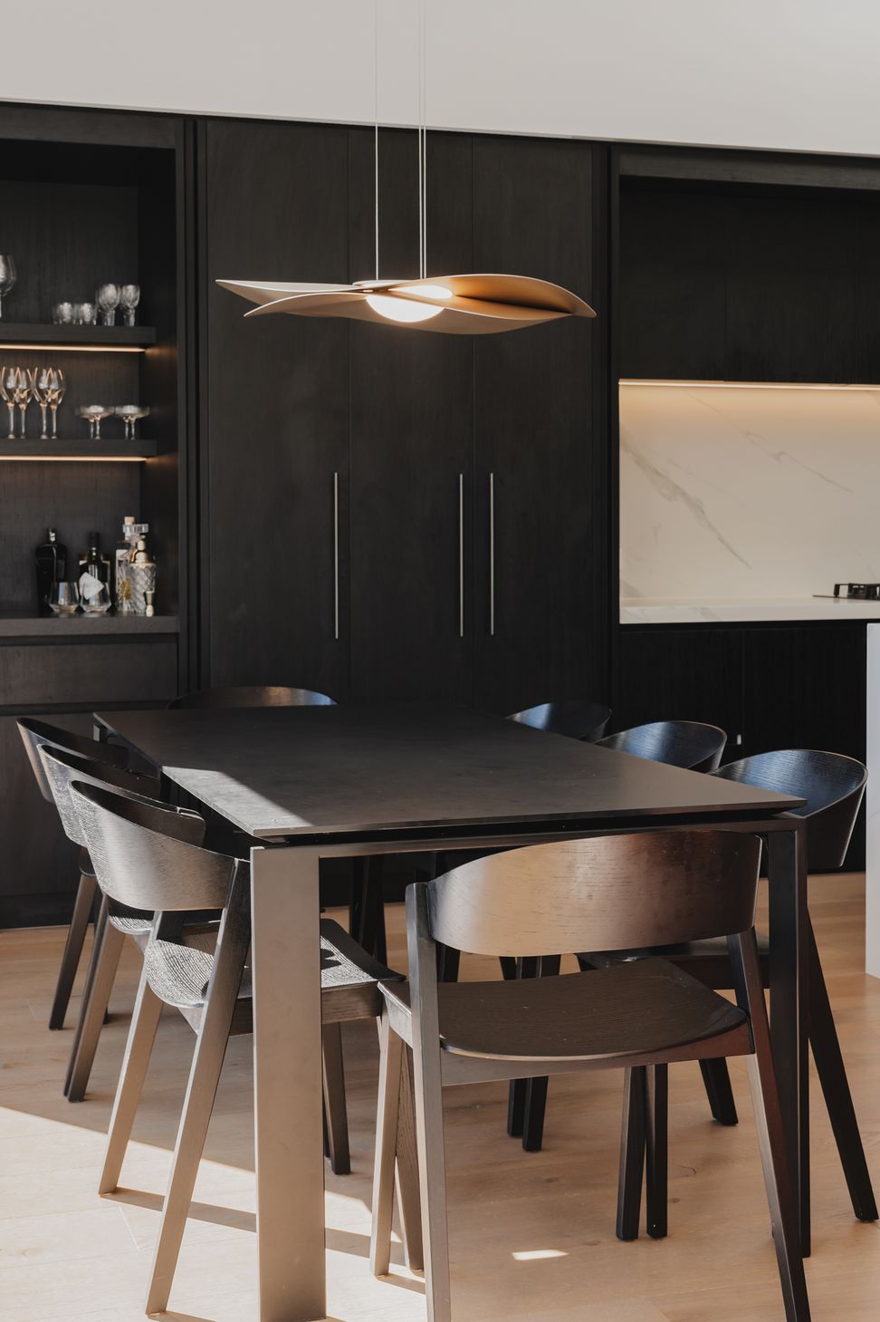 Westmere Bungalow | New-Build Residence | Internal view of open plan dining room and bespoke dark wood kitchen.