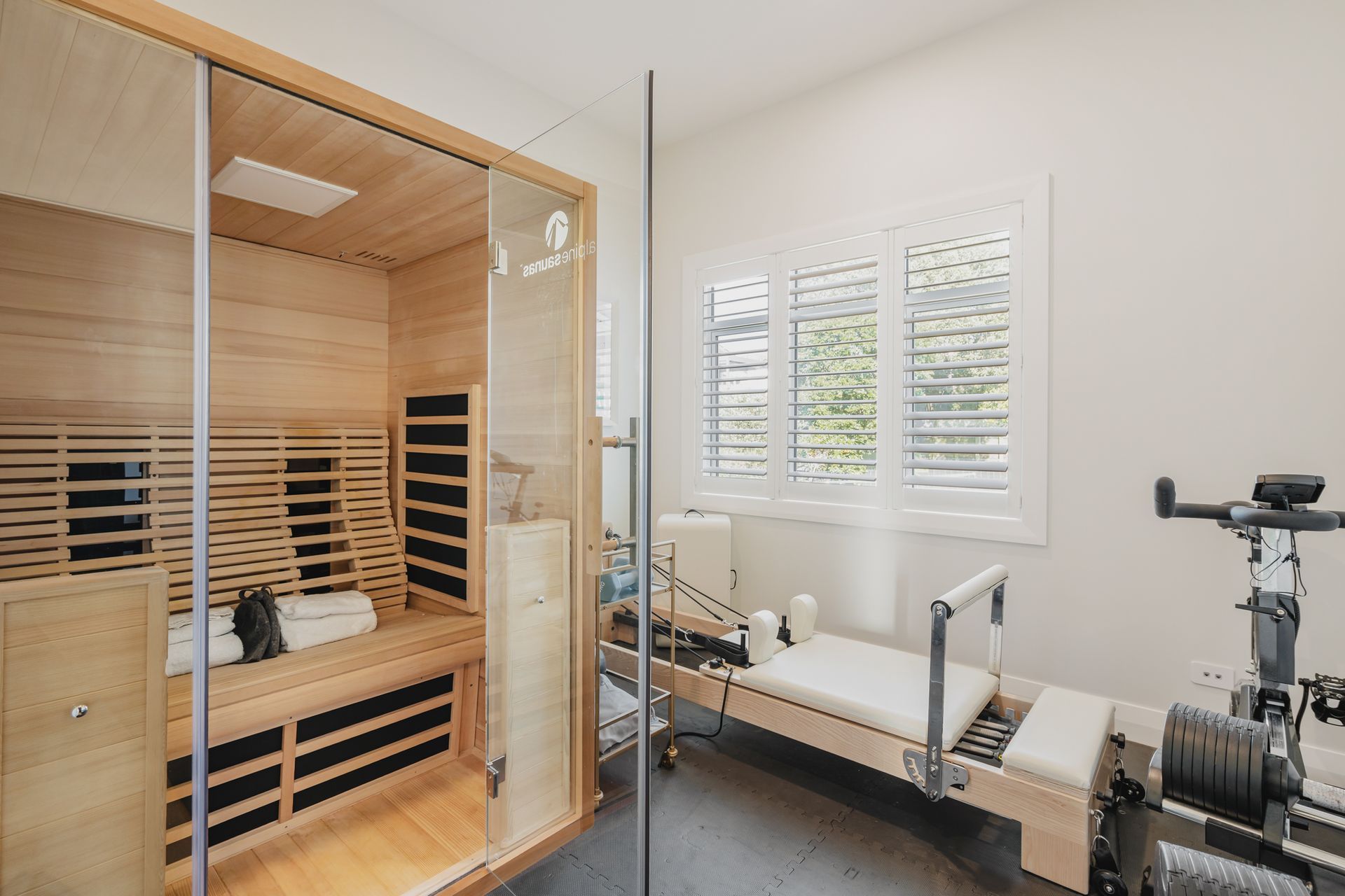 Westmere Bungalow | New-Build Residence | Internal view of gym room featuring infrared sauna, pilates reformer, peloton bike and weights.