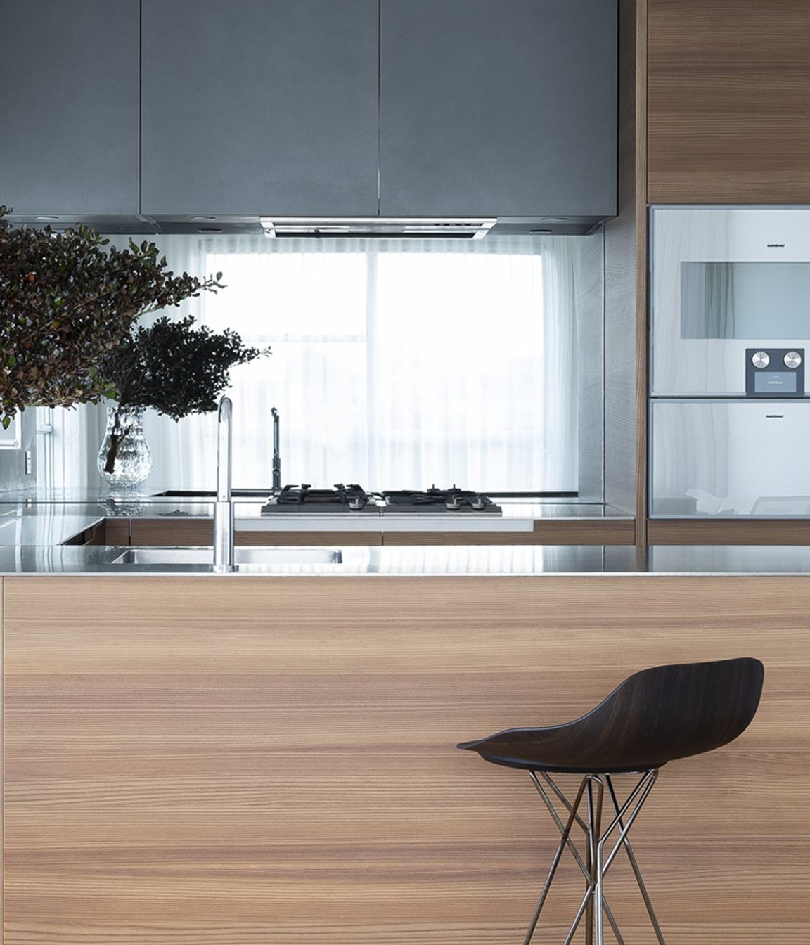 Left: Phoenix kitchen with Harmony Stool pulled up to the bench. Right: Poliform inserts, customised for the small format kitchen bench.