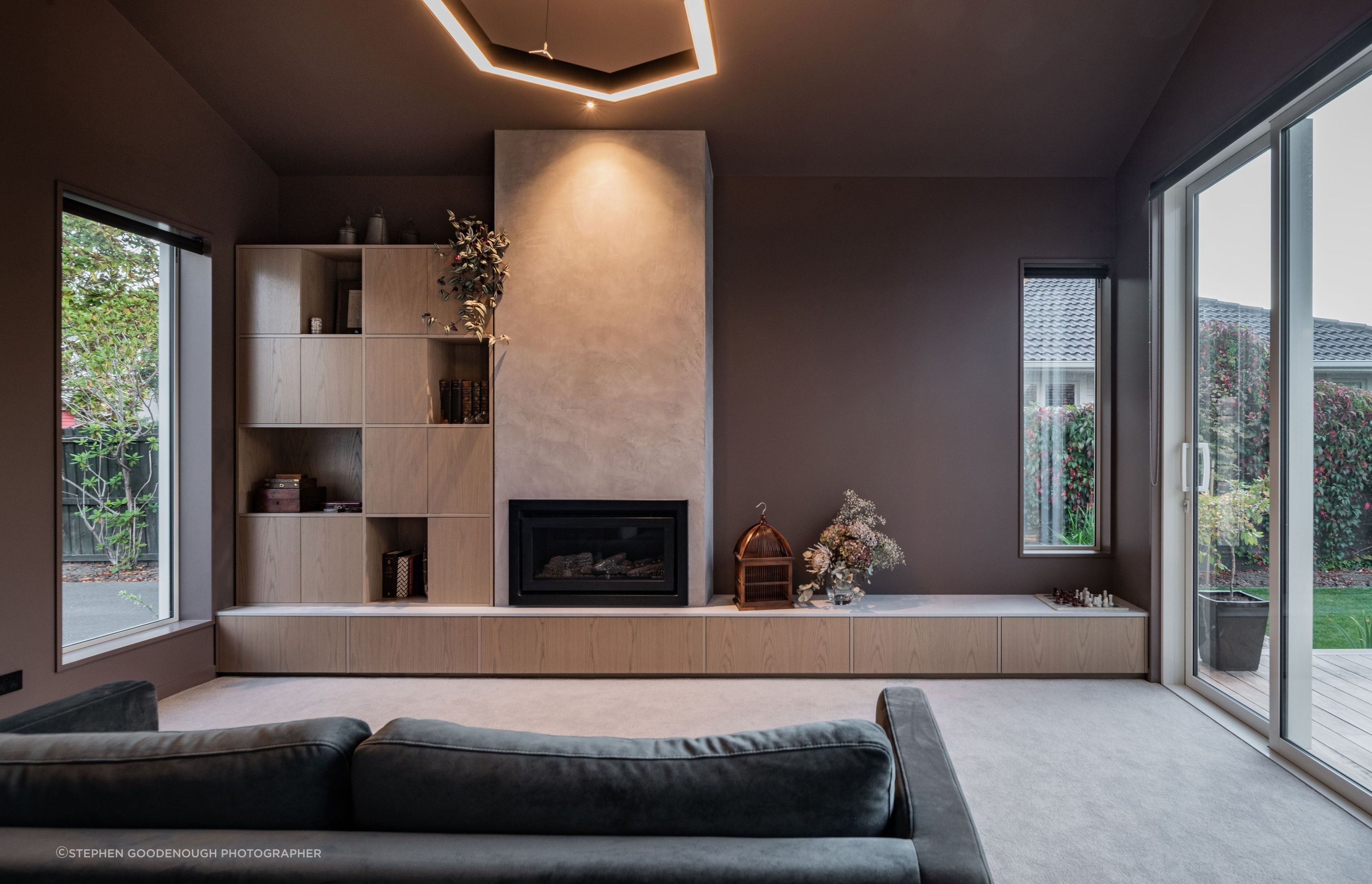A separate living area features a fireplace and darker colour palette.