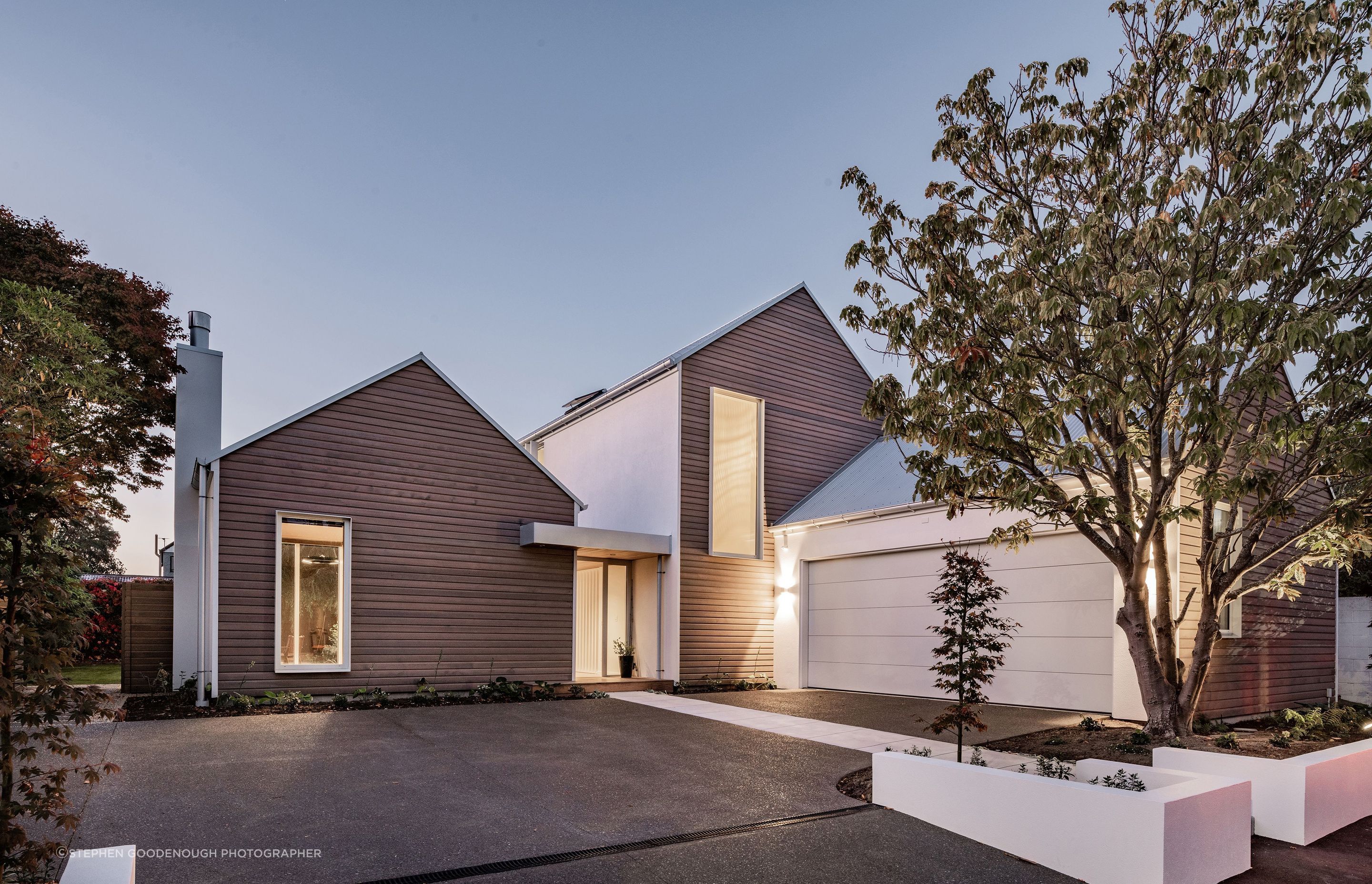 The homeowners wanted the build to complement the existing character homes on the street – cedar-clad gable forms achieve this.