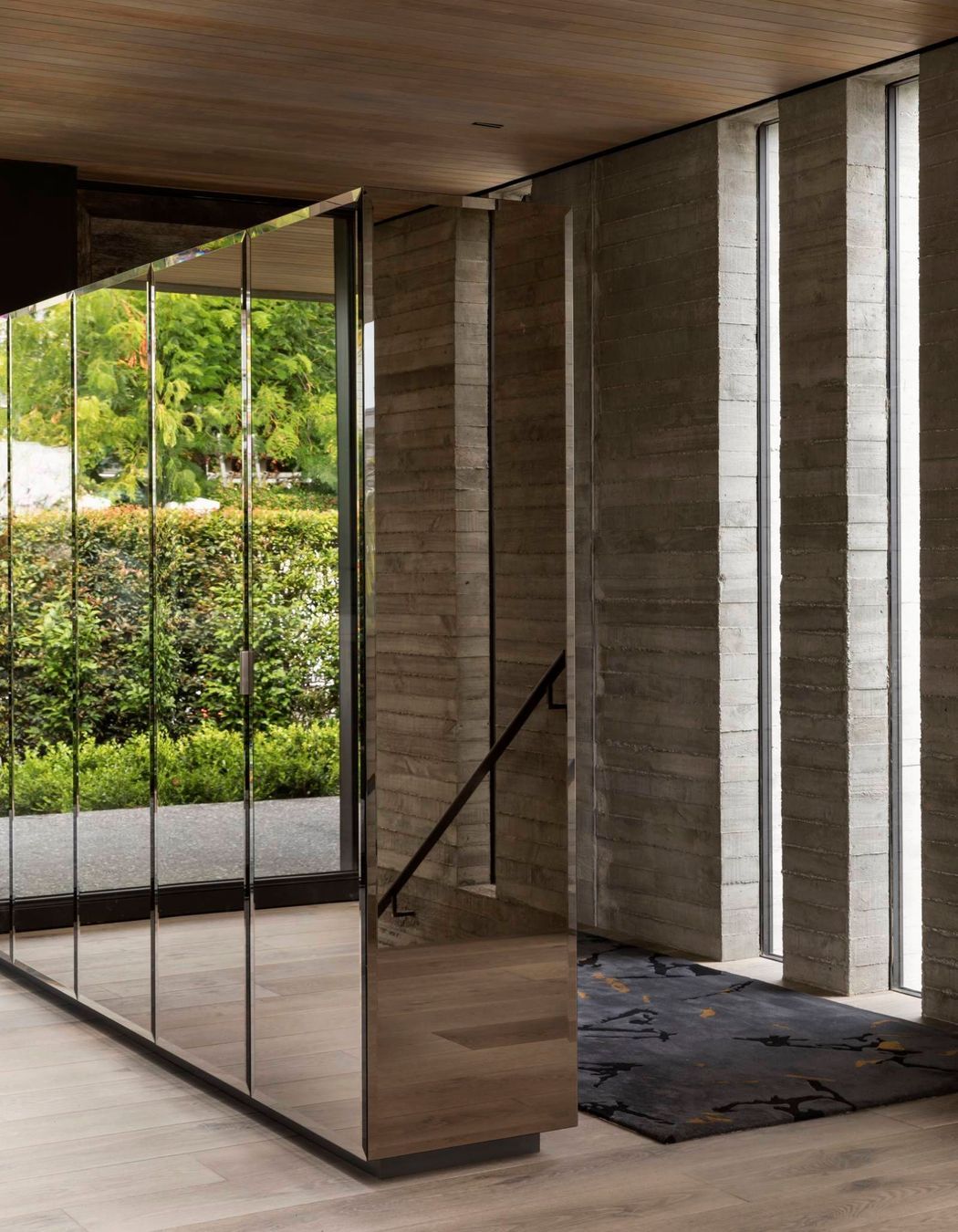 A built-in, mirrored unit separating the entry space from the dining area adds much-needed storage but also reflects the afternoon courtyard back into the house, making it visually accessible from almost any angle.