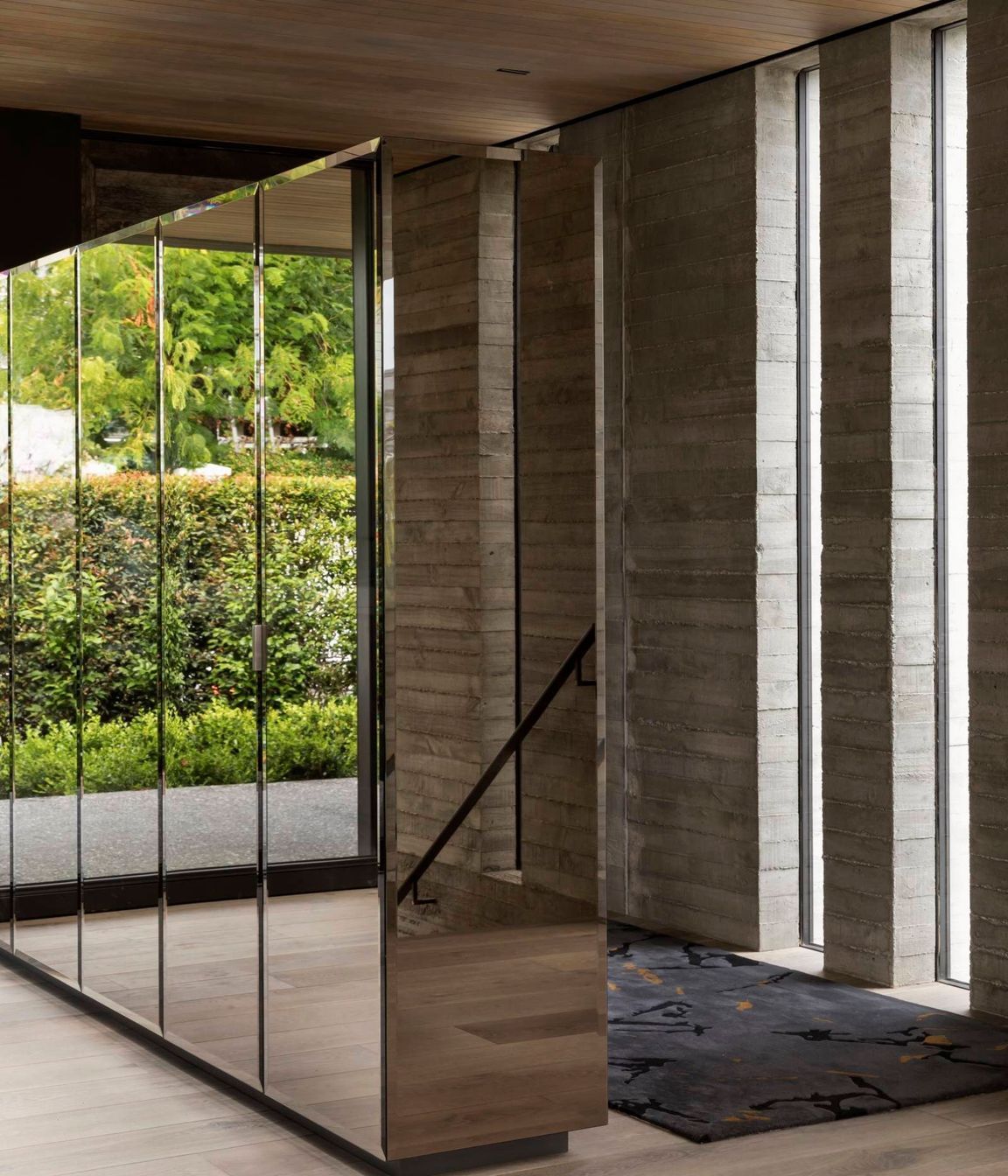 A built-in, mirrored unit separating the entry space from the dining area adds much-needed storage but also reflects the afternoon courtyard back into the house, making it visually accessible from almost any angle.