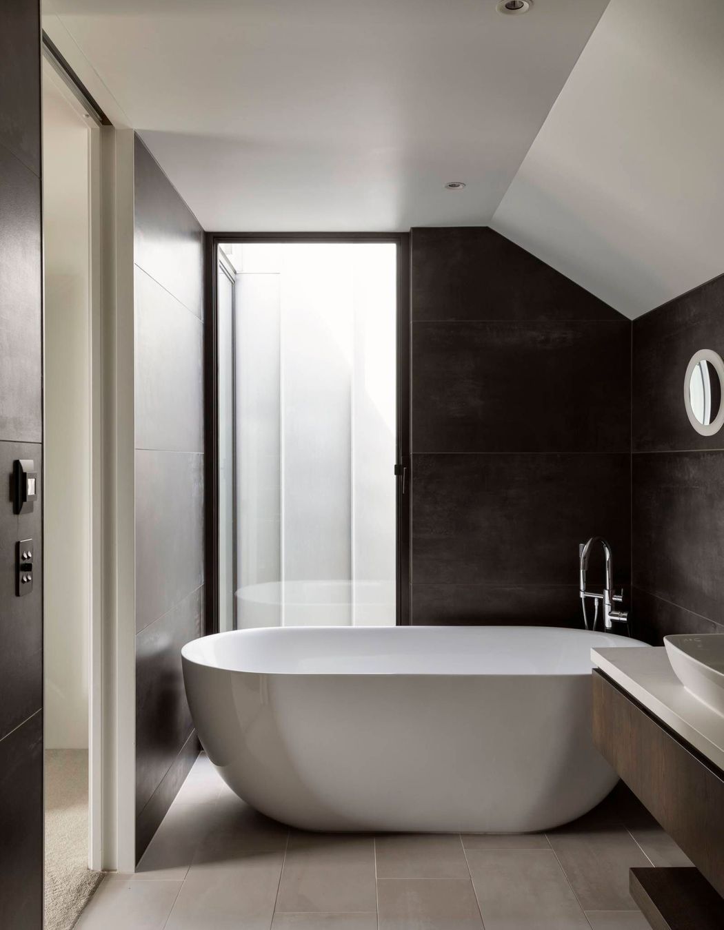 Tucked into the roof space, the master en suite enjoys natural light thanks to the second of two notches for which the house is named.