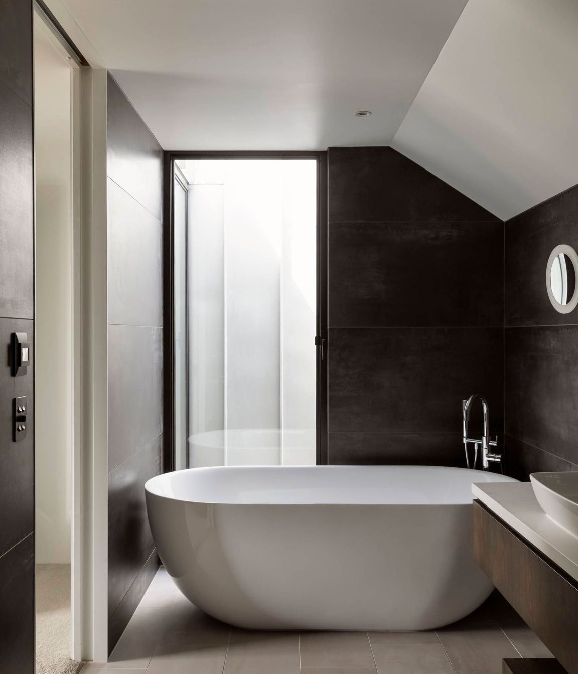 Tucked into the roof space, the master en suite enjoys natural light thanks to the second of two notches for which the house is named.