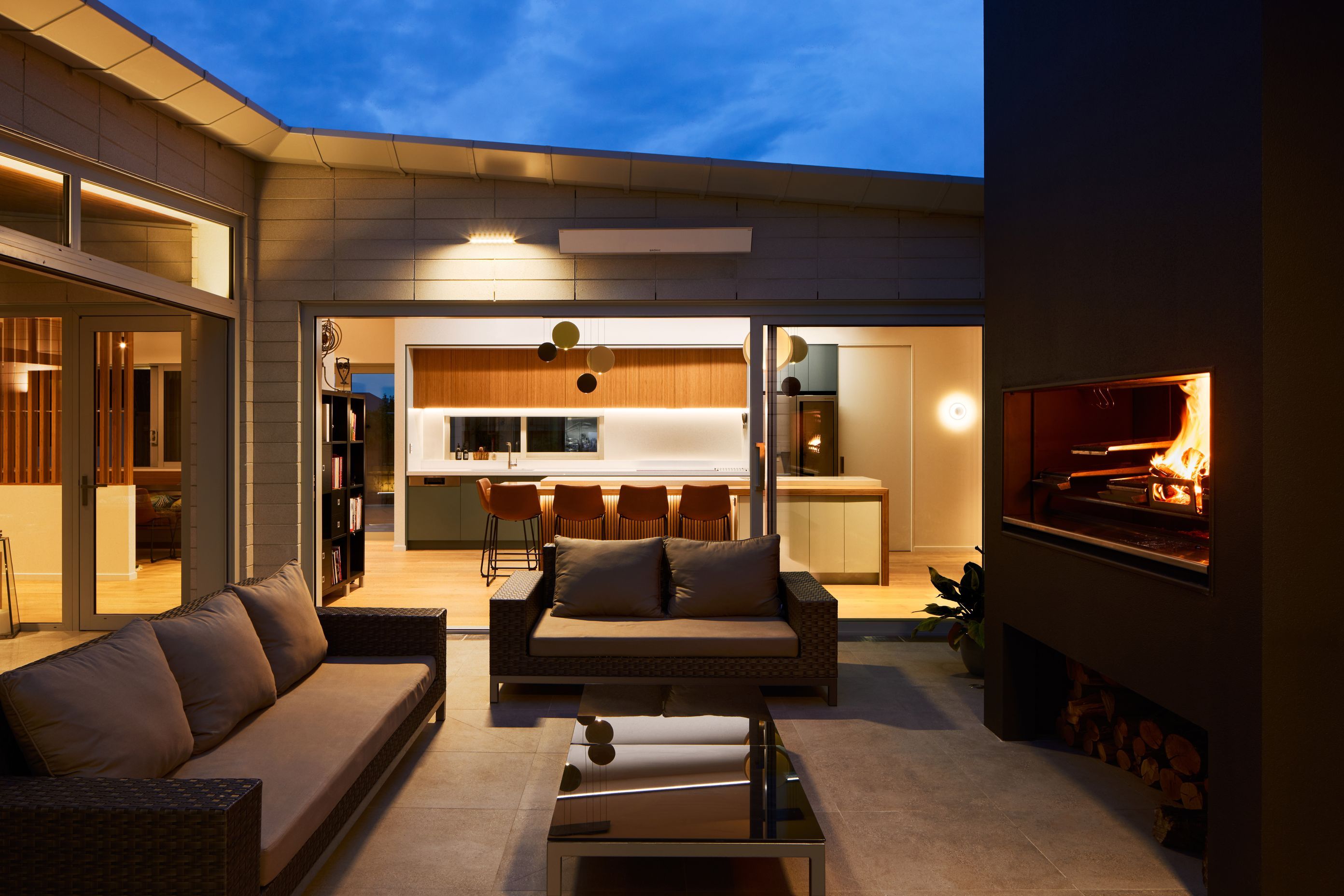 The courtyard is built around an outdoor kitchen, the Escea EK1550. “As a big entertainer and hailing from Spain, the homeowner cooks a lot of paella and asado-style meats.”
