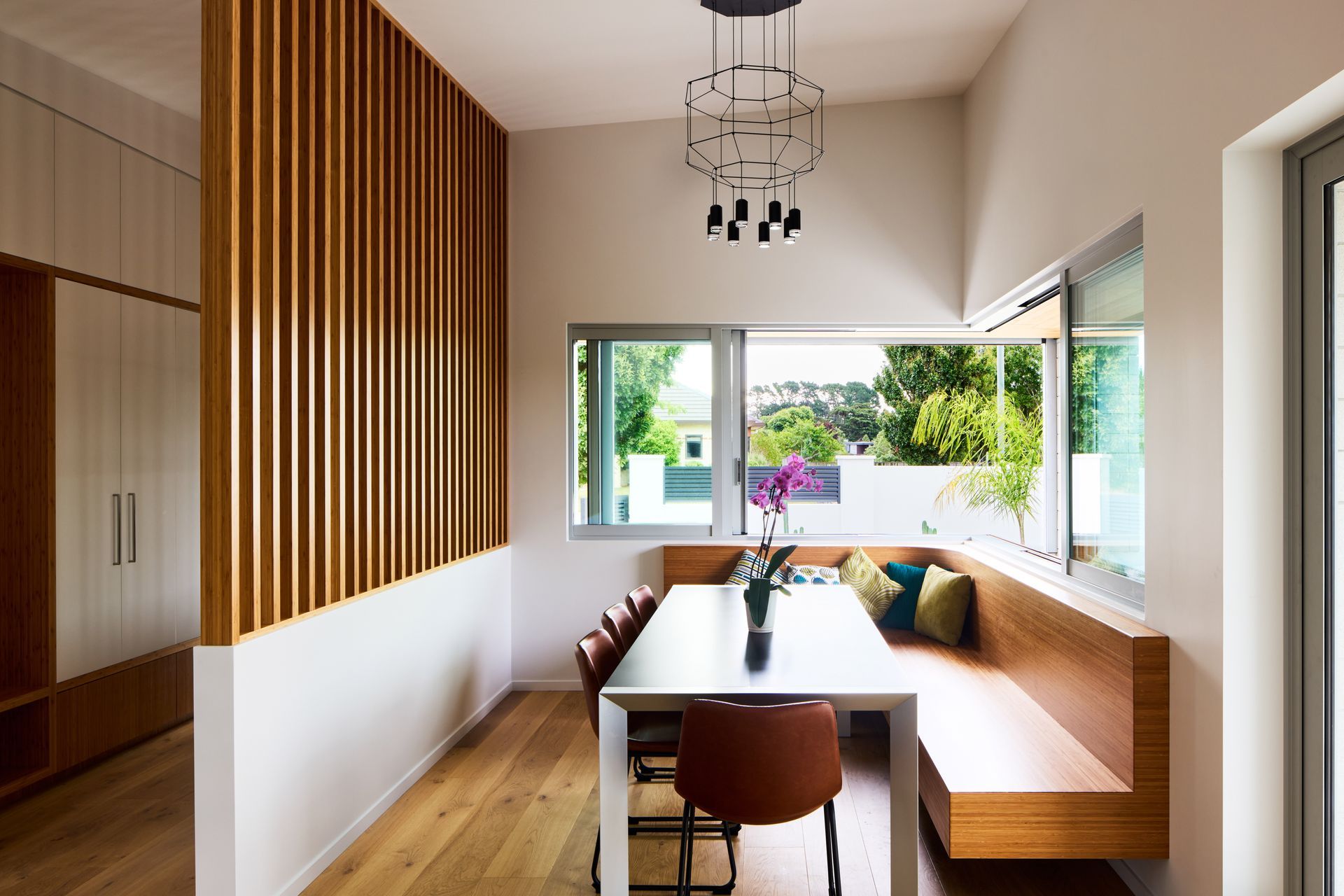 Bamboo joinery by The Woodsmiths was designed by First Light Studio for the kitchen, dining, bathrooms, laundry and master bedroom. “From a sustainability point of view, bamboo is a great product. And the client liked it. It has a different grain and is something that’s not as commonly used.” The hanging lamp is Wireflow by Vibia.