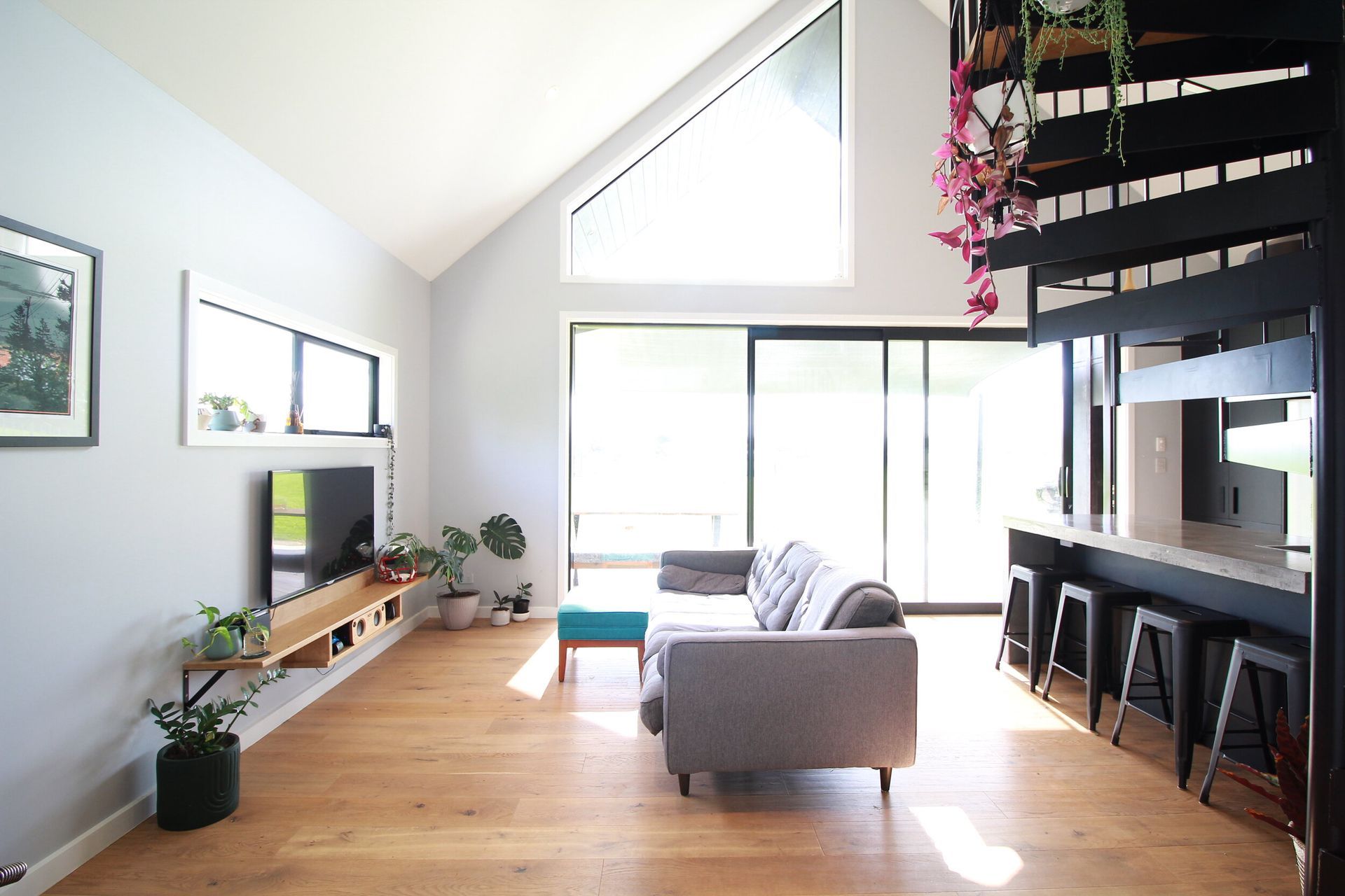 Over sized sliding joinery create a huge living space with the a-symmetrical window allowing us to showcase the beautiful cedar cladding on the main gable wall outside.