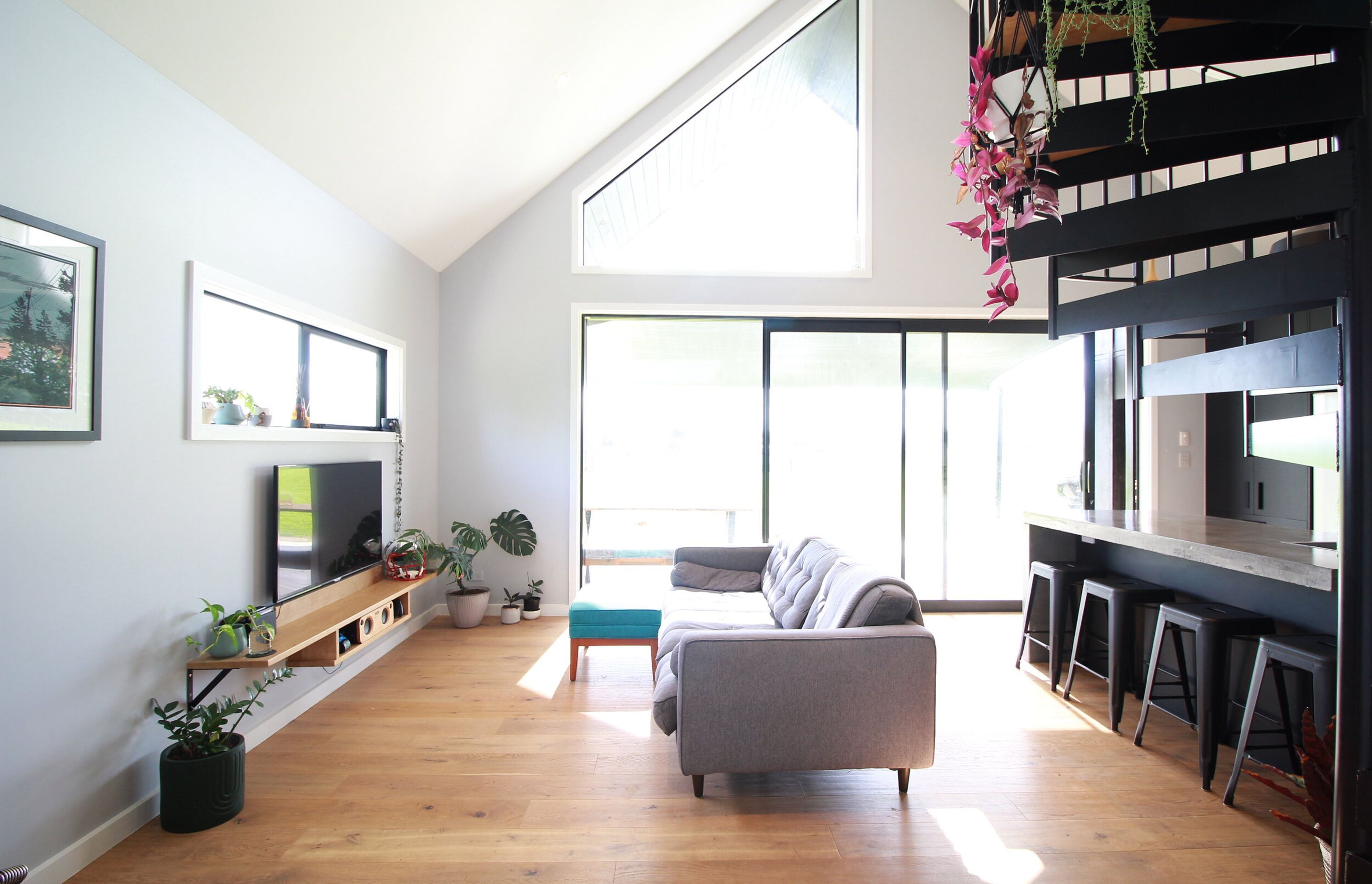 Over sized sliding joinery create a huge living space with the a-symmetrical window allowing us to showcase the beautiful cedar cladding on the main gable wall outside.