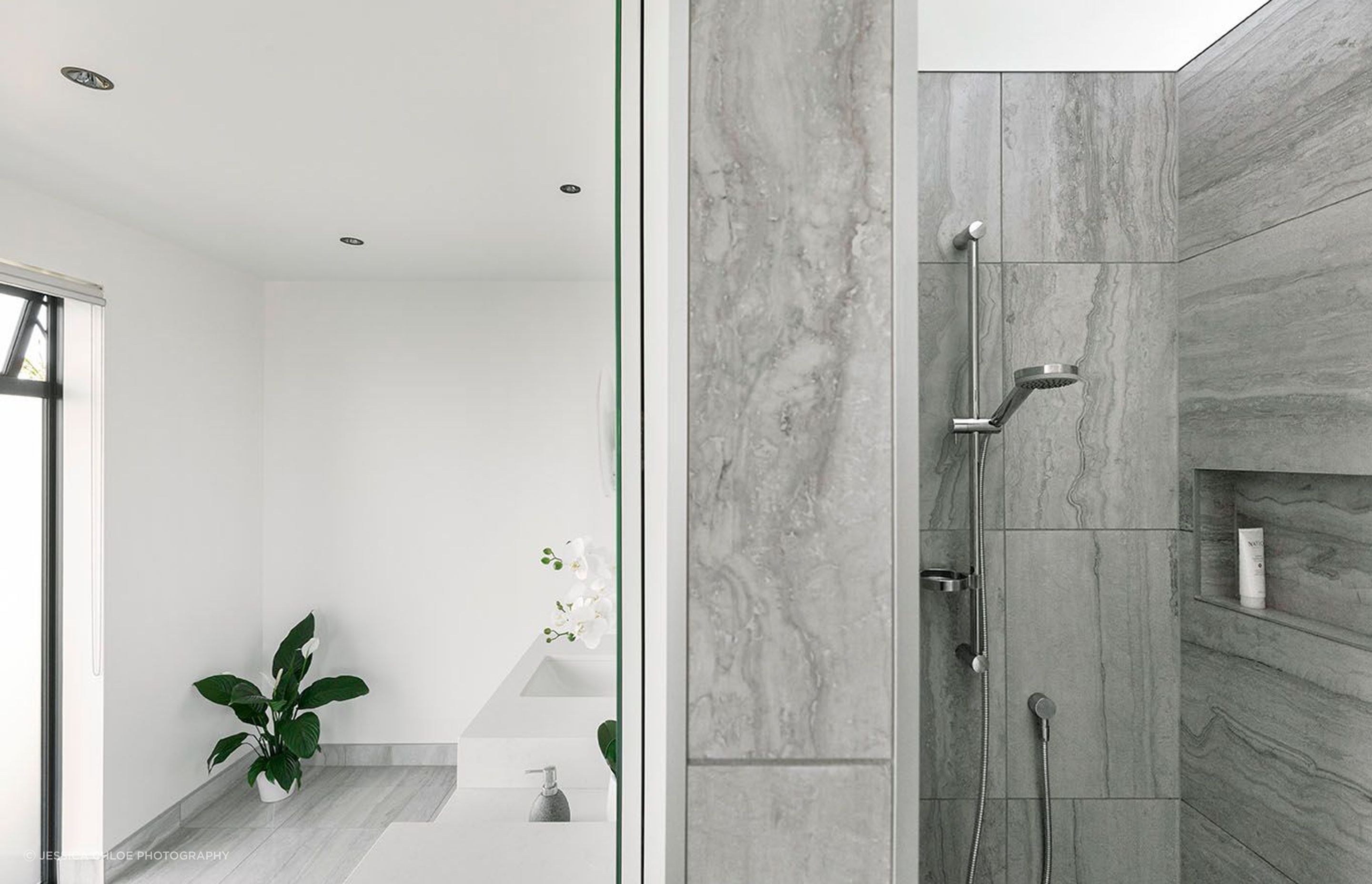 Bathroom features open spaces to enter on both sides, one to the walk in shower and other to the toilet, a double basin adorns the front wall