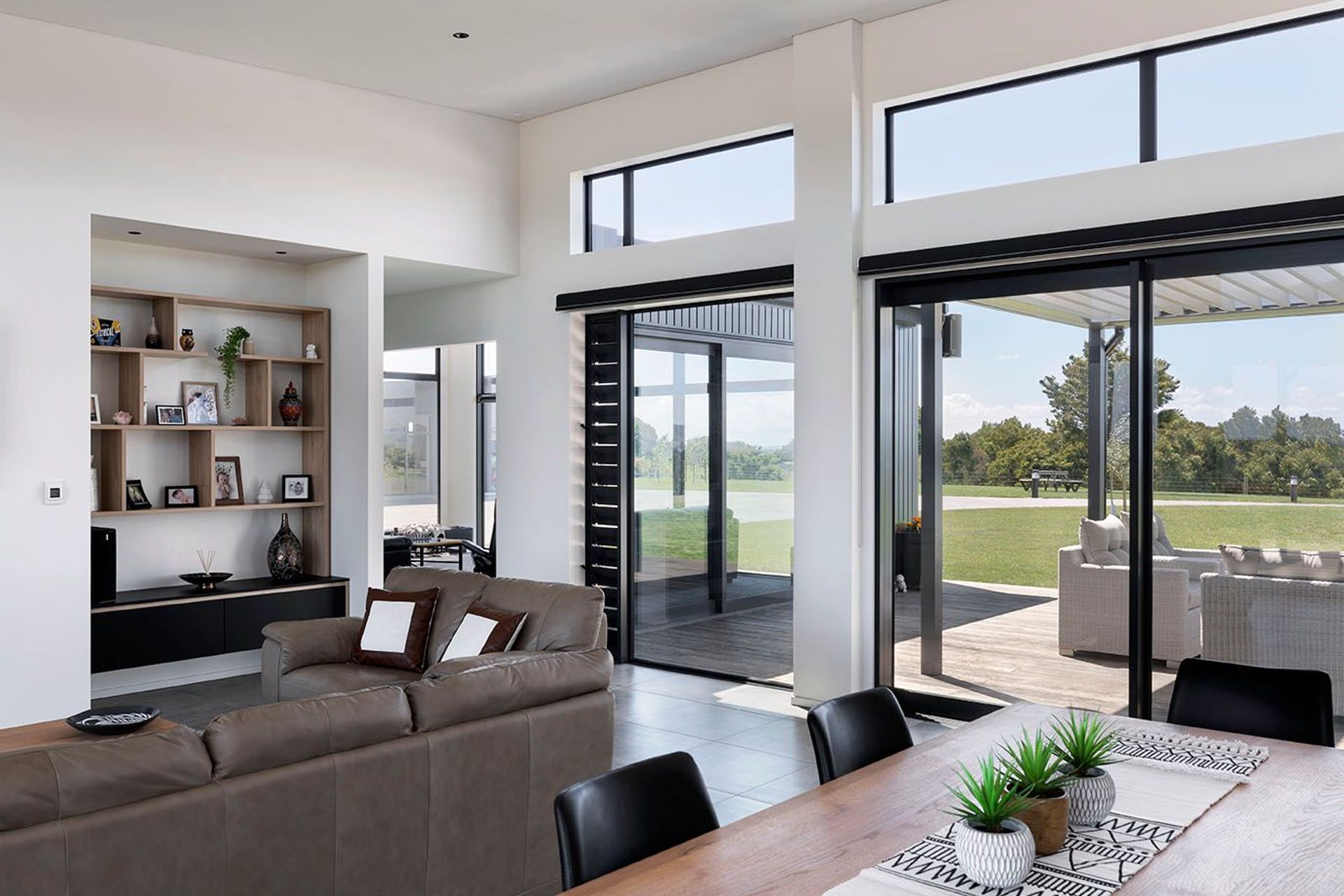 Larger open plan living spaces flow through to a more private quiet sitting room that helps frame the external sitting spaces