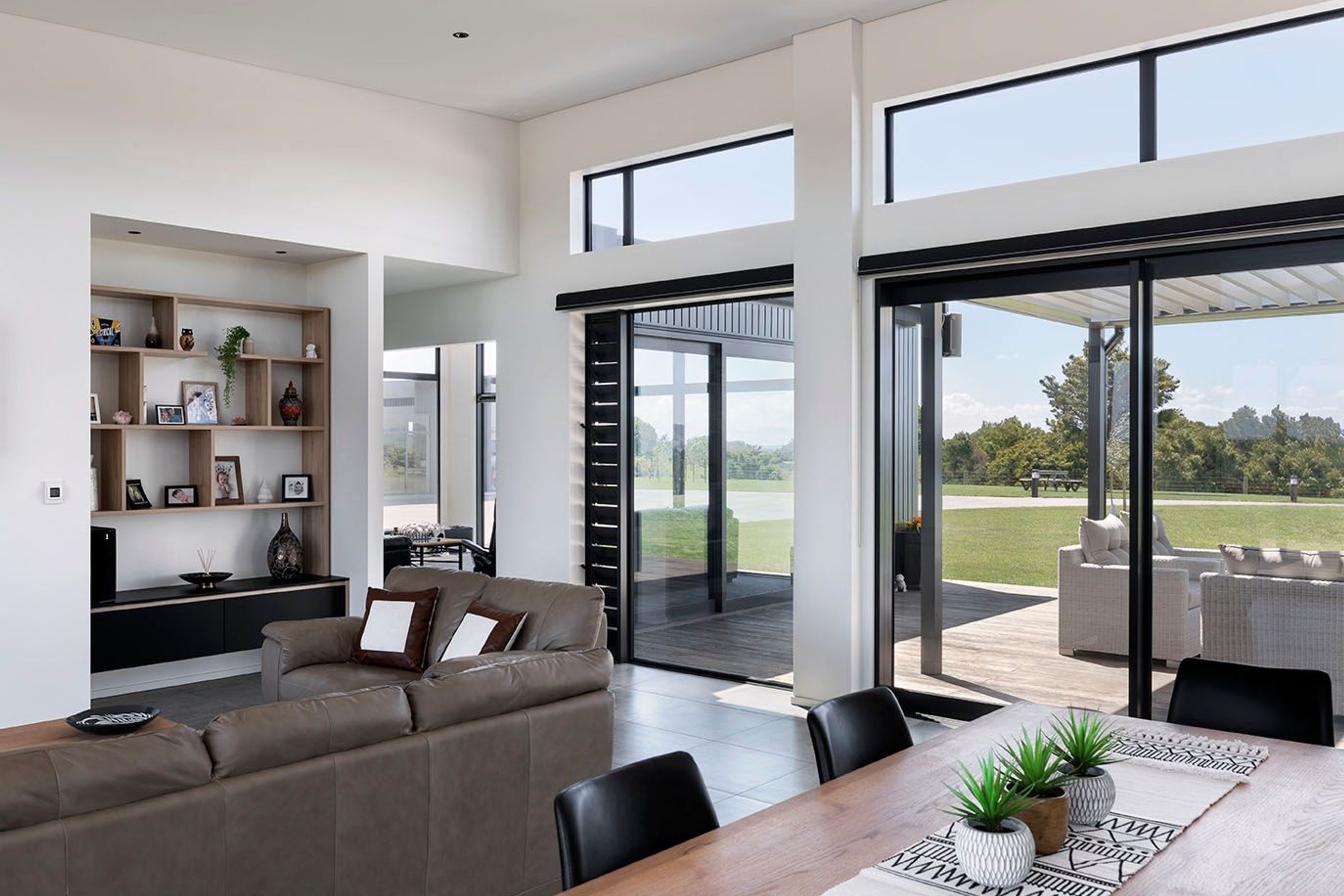 Larger open plan living spaces flow through to a more private quiet sitting room that helps frame the external sitting spaces