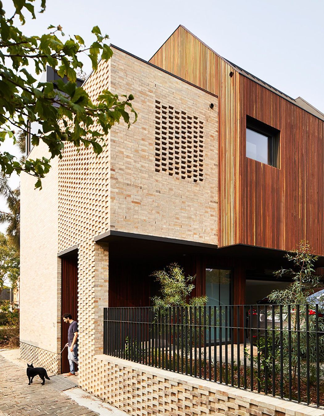 Dimpled brickwork at the base of the building adds an extra layer of texture