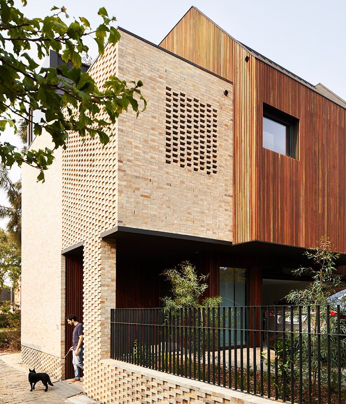 Dimpled brickwork at the base of the building adds an extra layer of texture