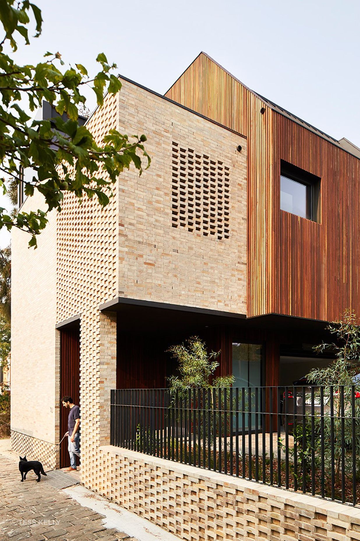 Dimpled brickwork at the base of the building adds an extra layer of texture