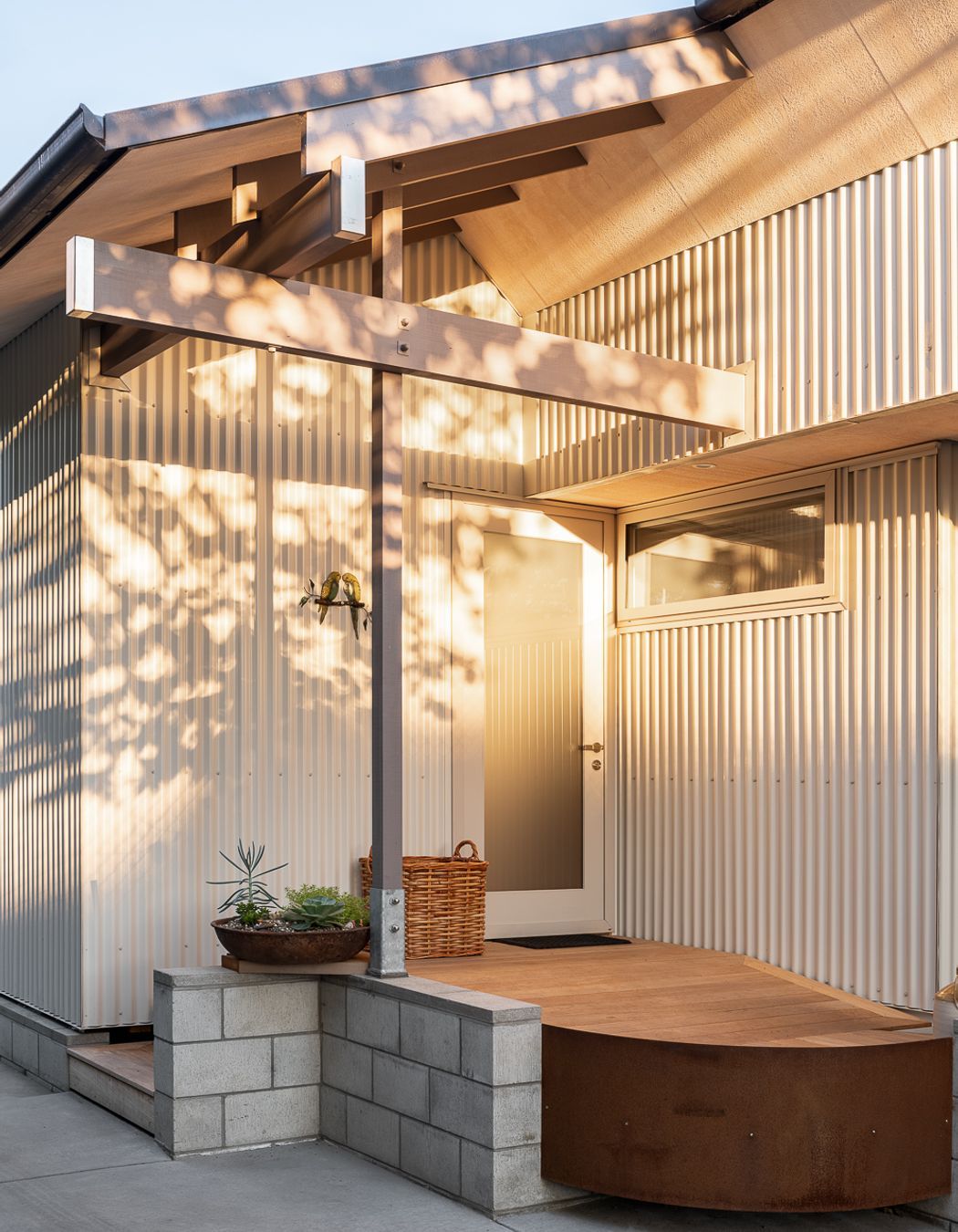 The entrance is humble and accessed on one side of the home from the driveway.