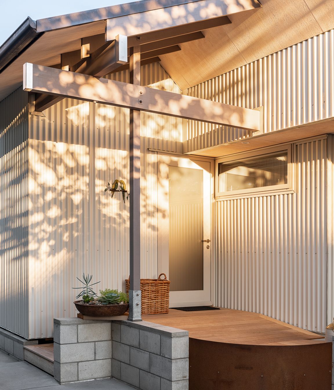 The entrance is humble and accessed on one side of the home from the driveway.