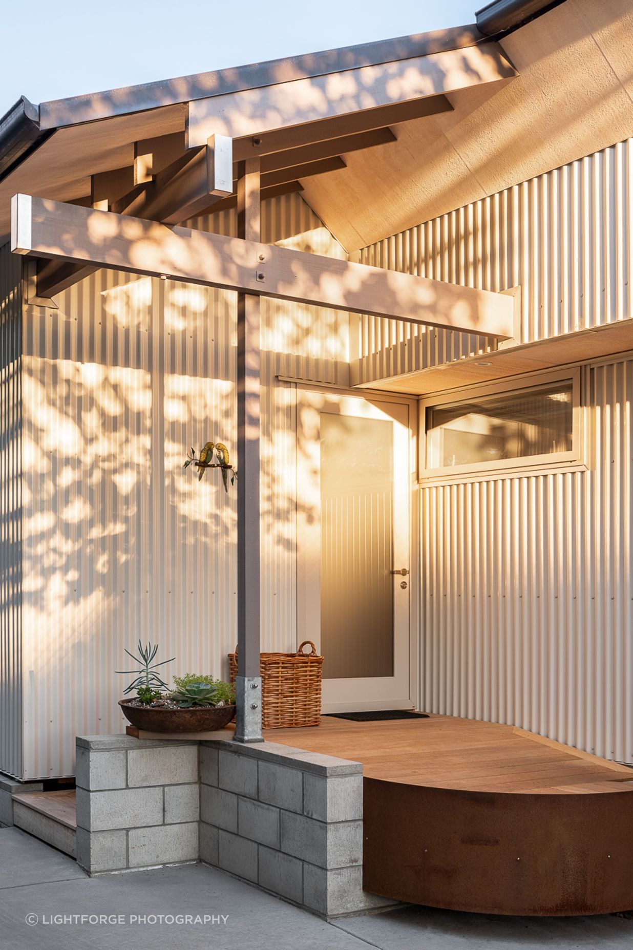The entrance is humble and accessed on one side of the home from the driveway.