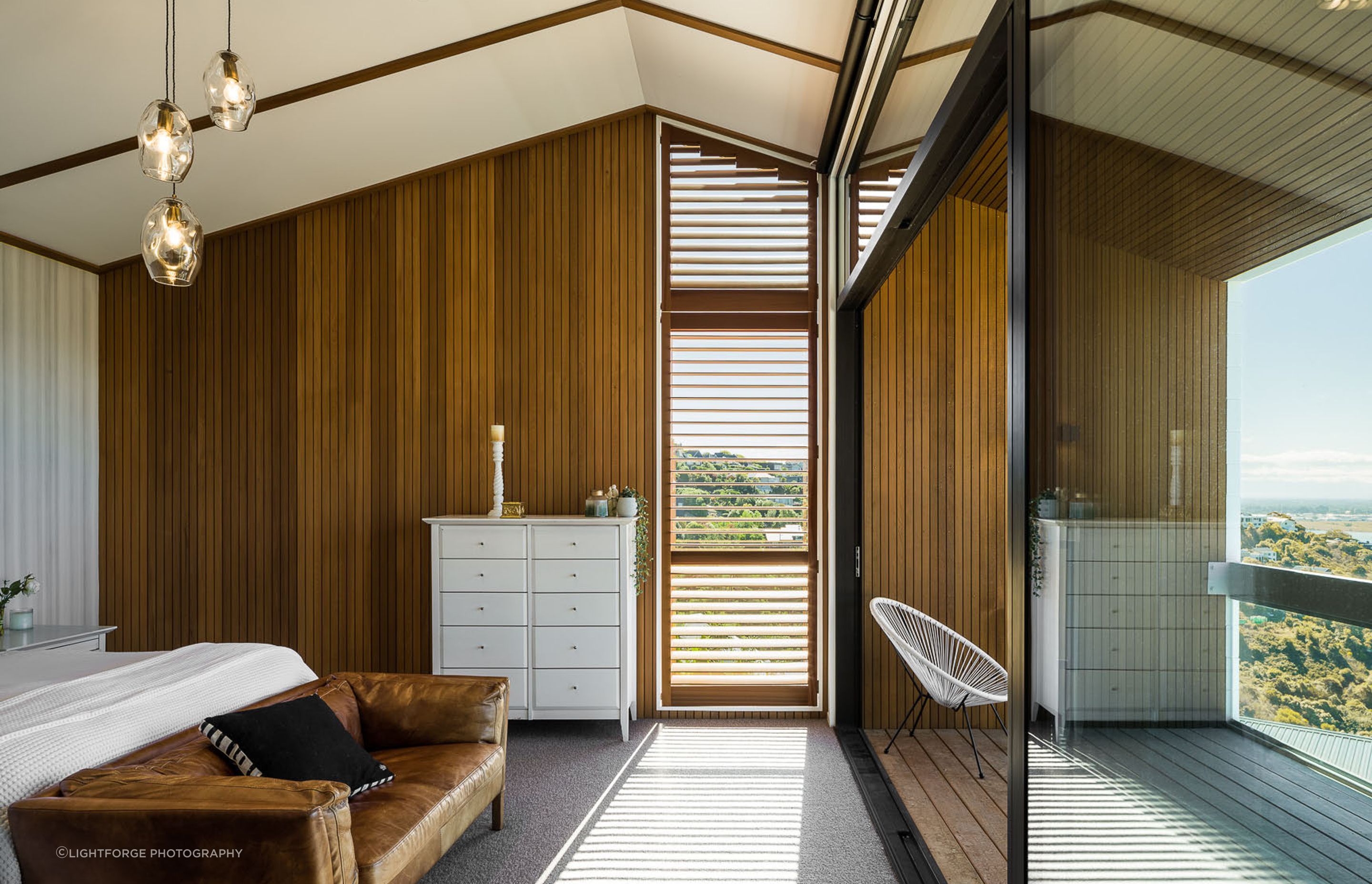 Shiplap vertical weatherboards have been used both internally and externally to impart a sense of the bedroom and verandah being connected spaces.