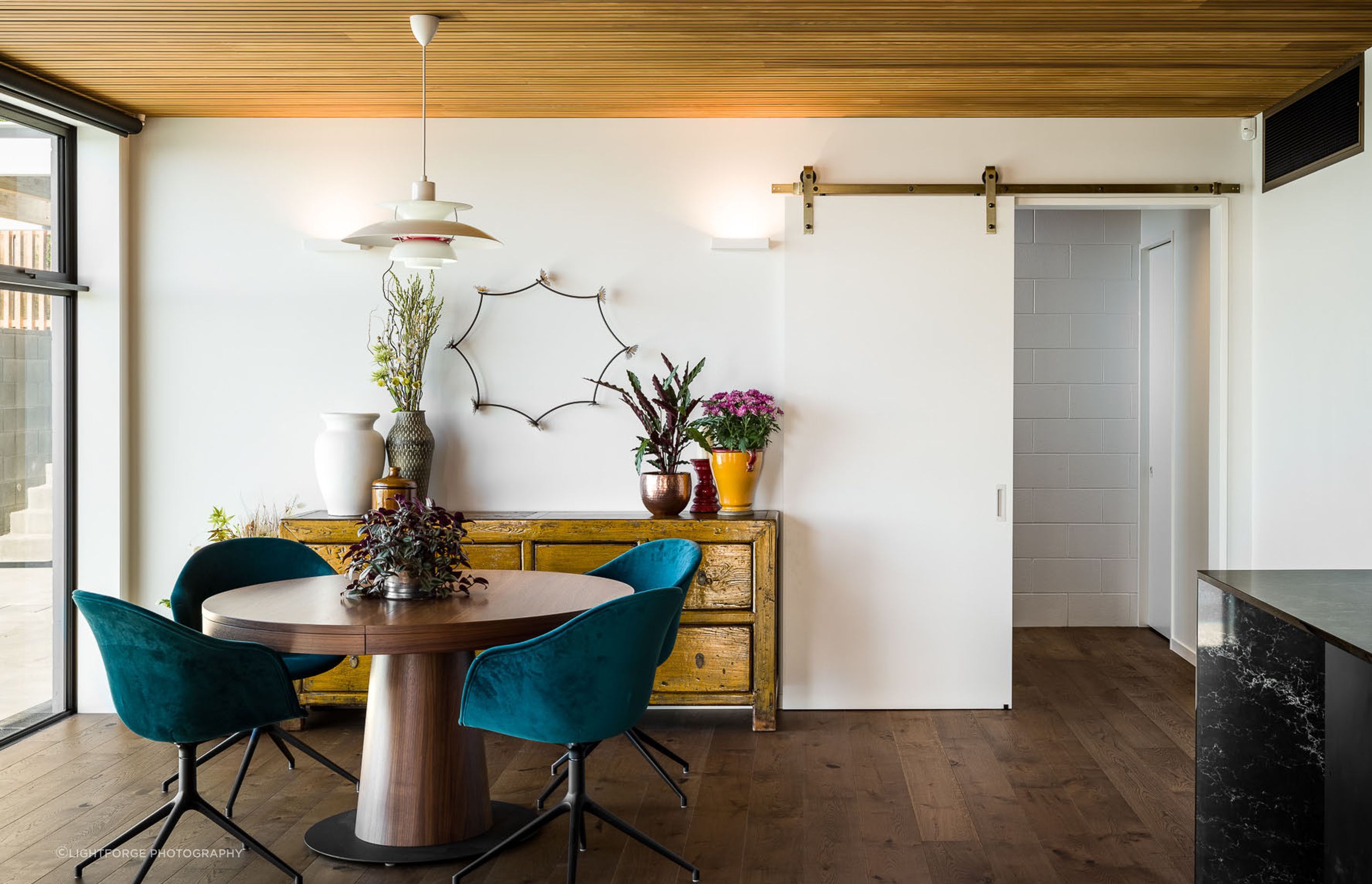 An eclectic mix of furniture and accessories complements the architectural styling creating a classic modern interior.