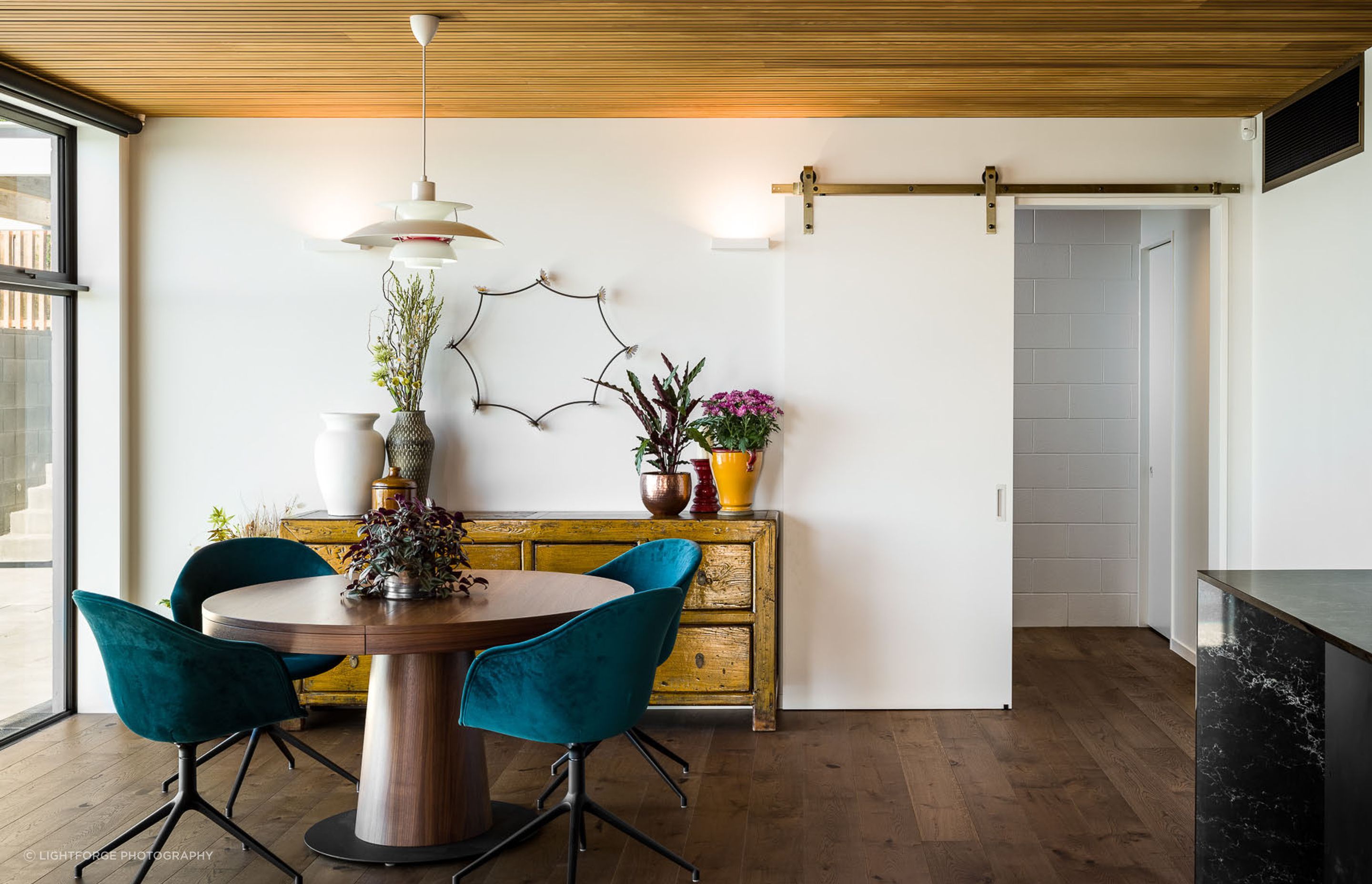 An eclectic mix of furniture and accessories complements the architectural styling creating a classic modern interior.