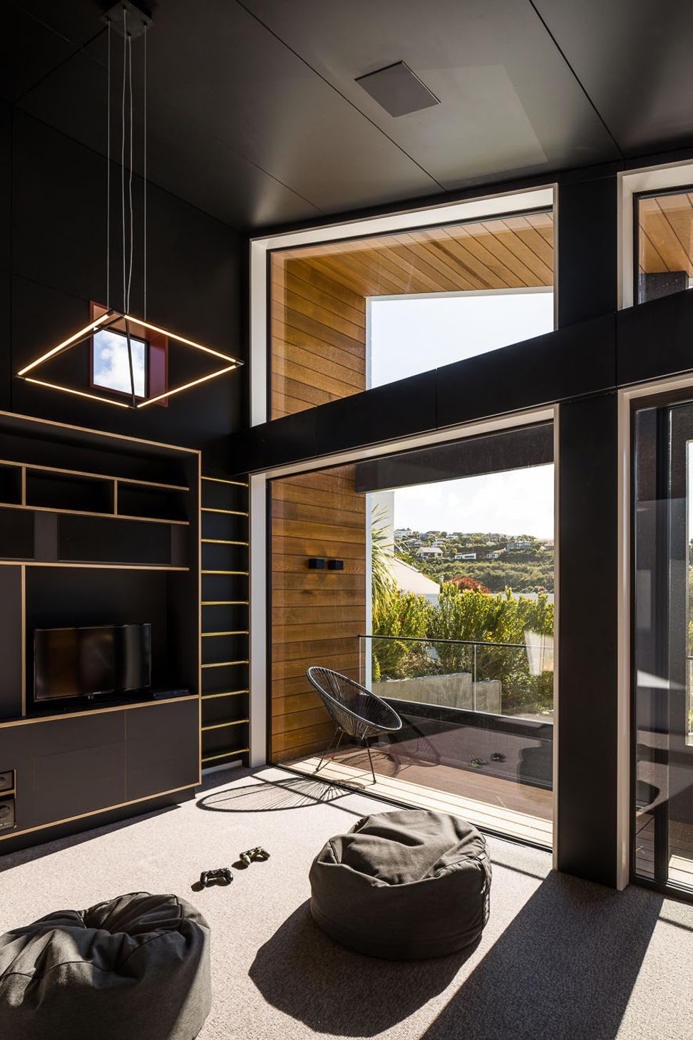 Located above the garage, the rumpus room is an area for the kids to relax in. The palette is dramatic and different to anything else in the house.
