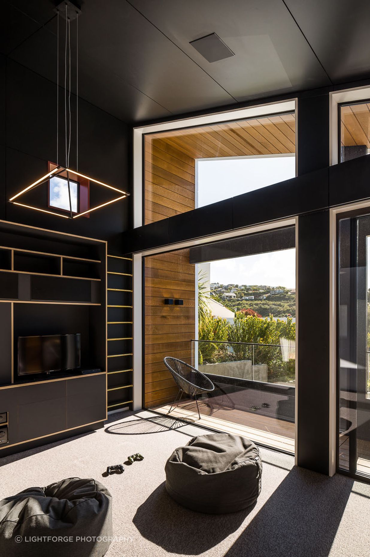 Located above the garage, the rumpus room is an area for the kids to relax in. The palette is dramatic and different to anything else in the house.