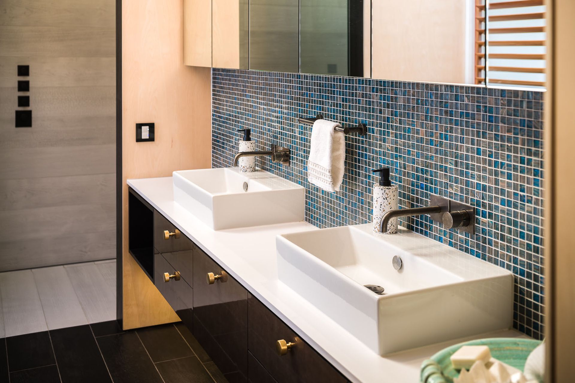 A mix of materials in the main ensuite continues the eclectic vibe found throughout the home.