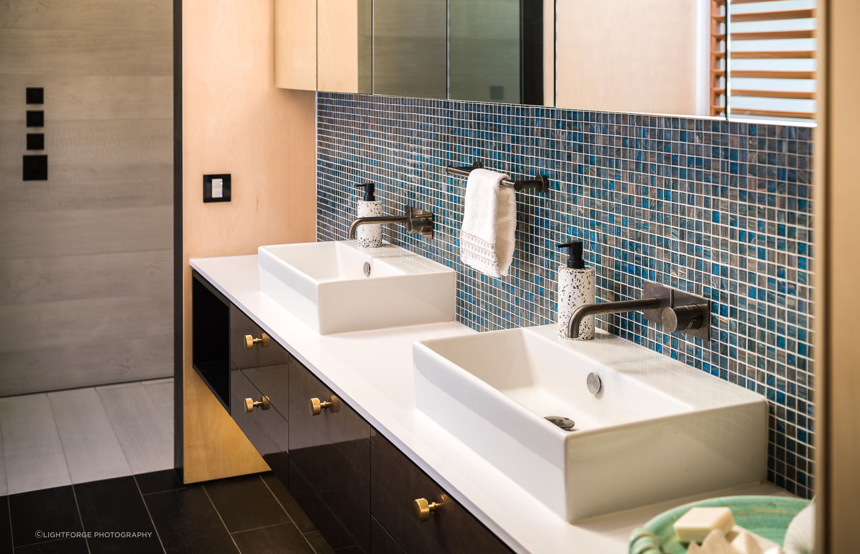 A mix of materials in the main ensuite continues the eclectic vibe found throughout the home.