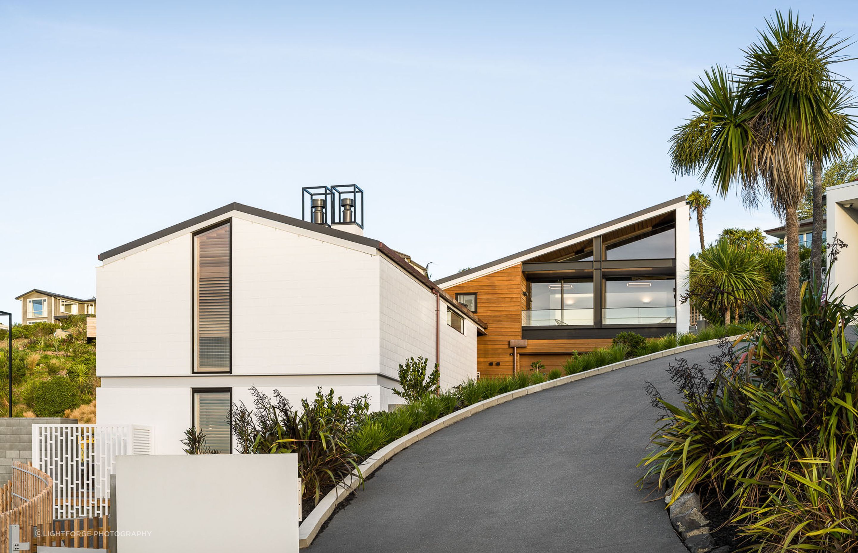 The house has been arranged over three split levels with a further portion built over the garage and clad in timber weather boards.