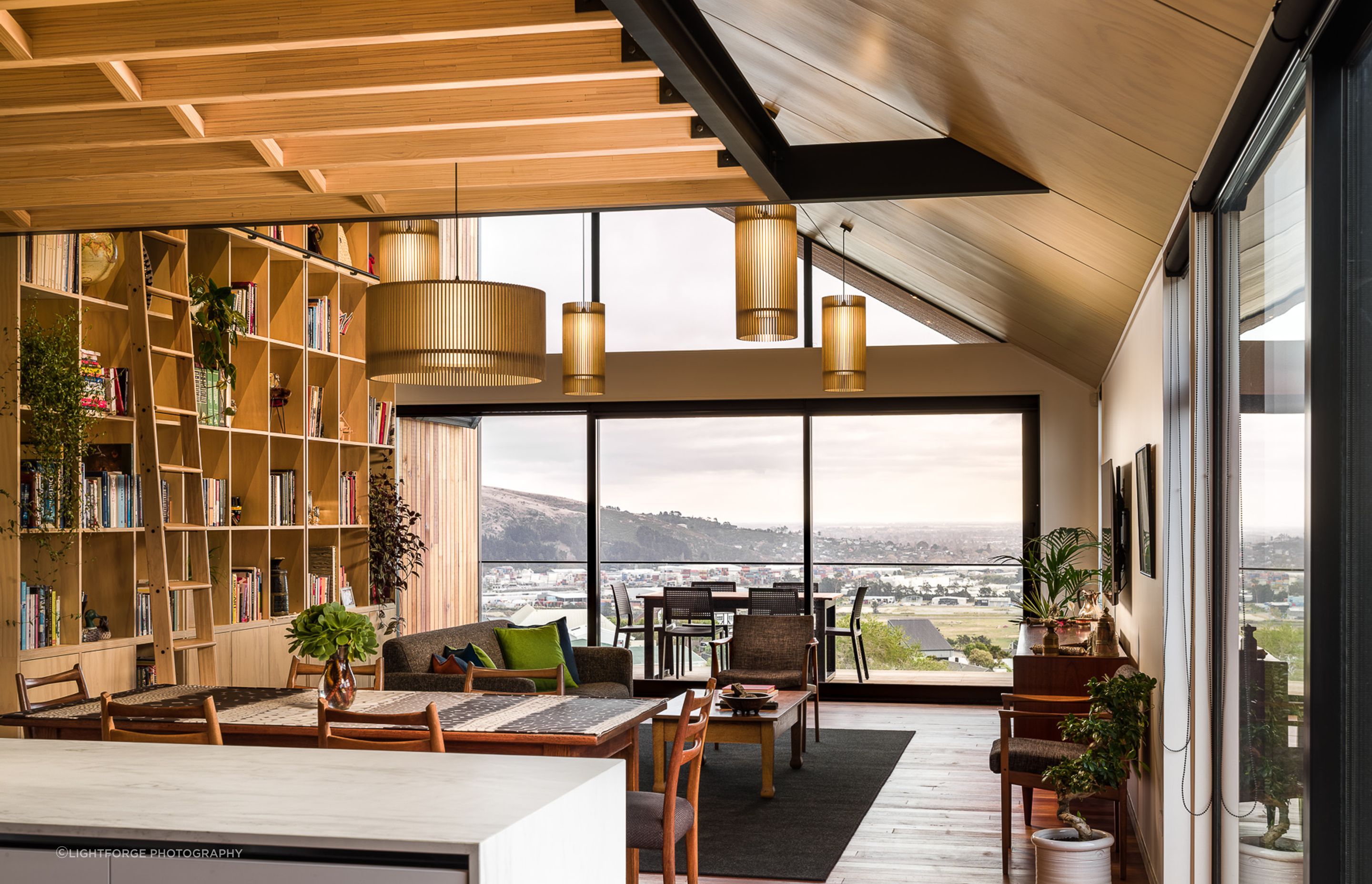 Expansive glazing on the west-facing facade opens the home to the wide-ranging view across the basin towards the Southern Alps.