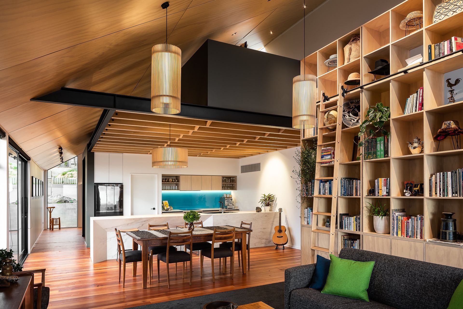 The open-plan living area features a range of timbers—a design feature that pays homage to one of the clients' love of woodworking.