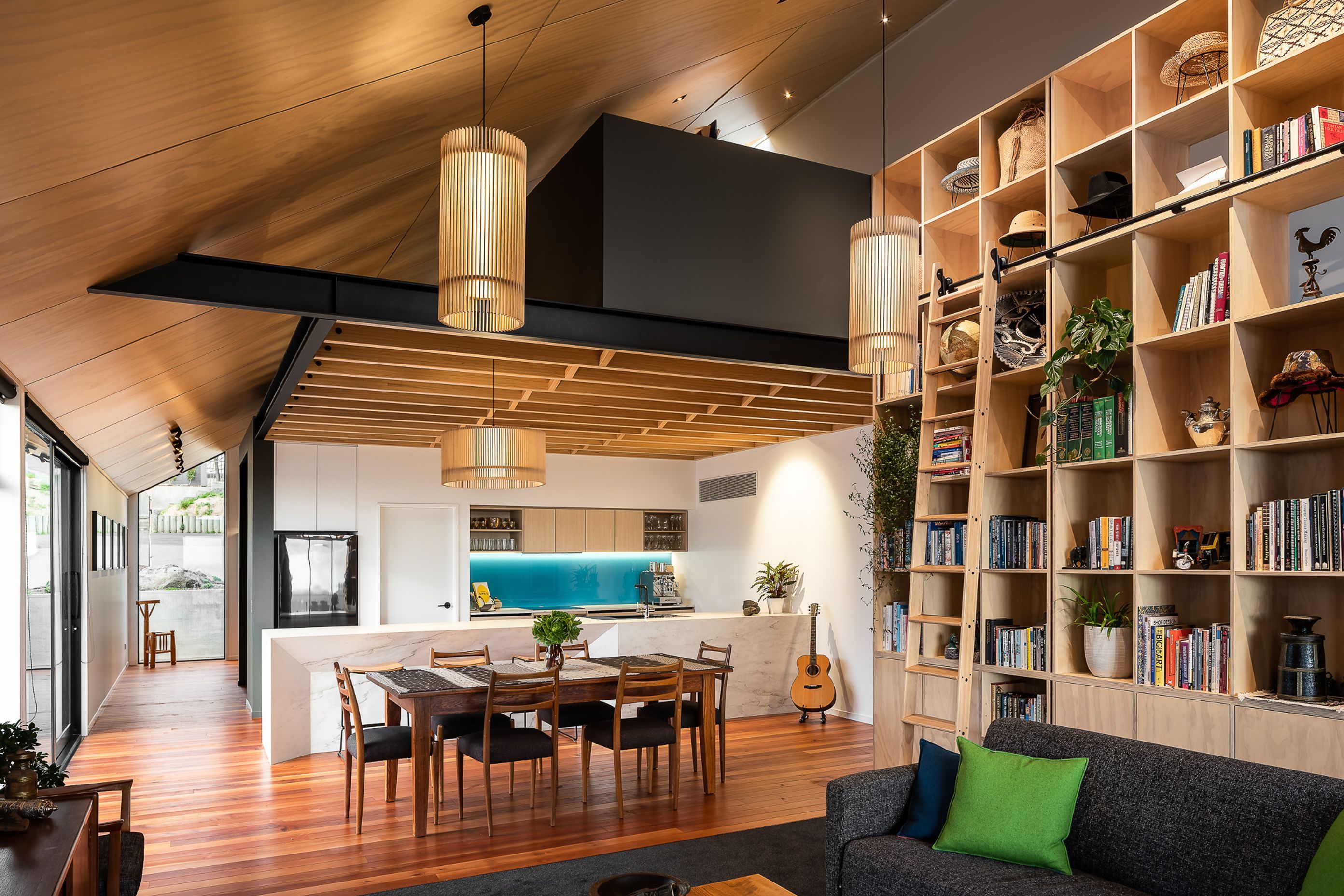 The open-plan living area features a range of timbers—a design feature that pays homage to one of the clients' love of woodworking.