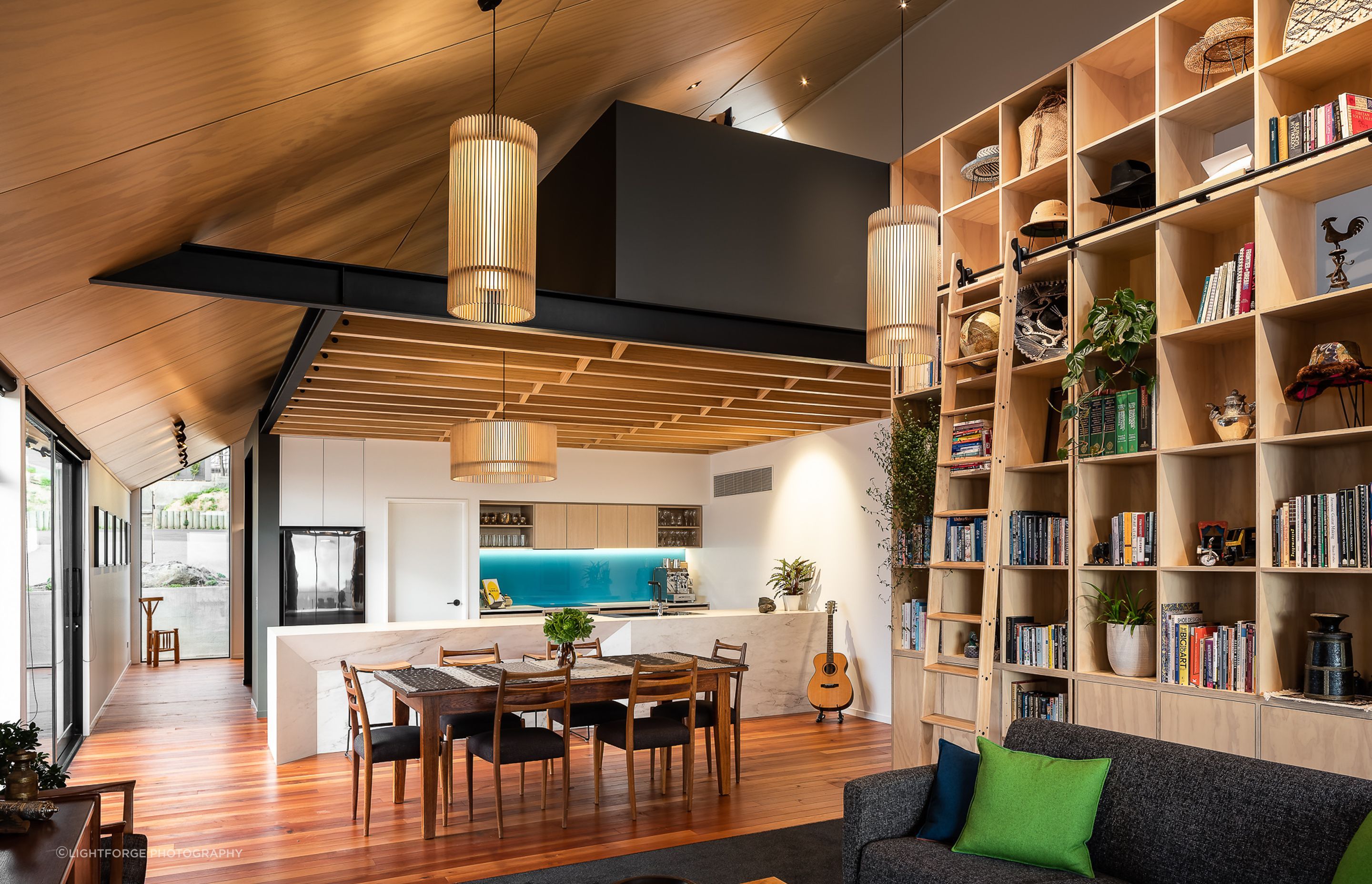 The open-plan living area features a range of timbers—a design feature that pays homage to one of the clients' love of woodworking.