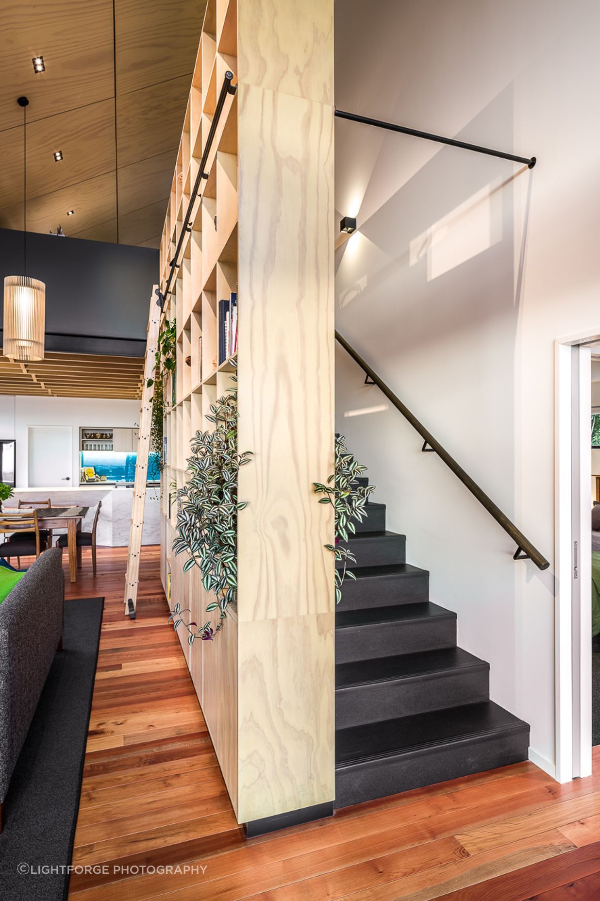 As well as providing storage for a range of items, the bookcase element also serves as structural support for the staircase.