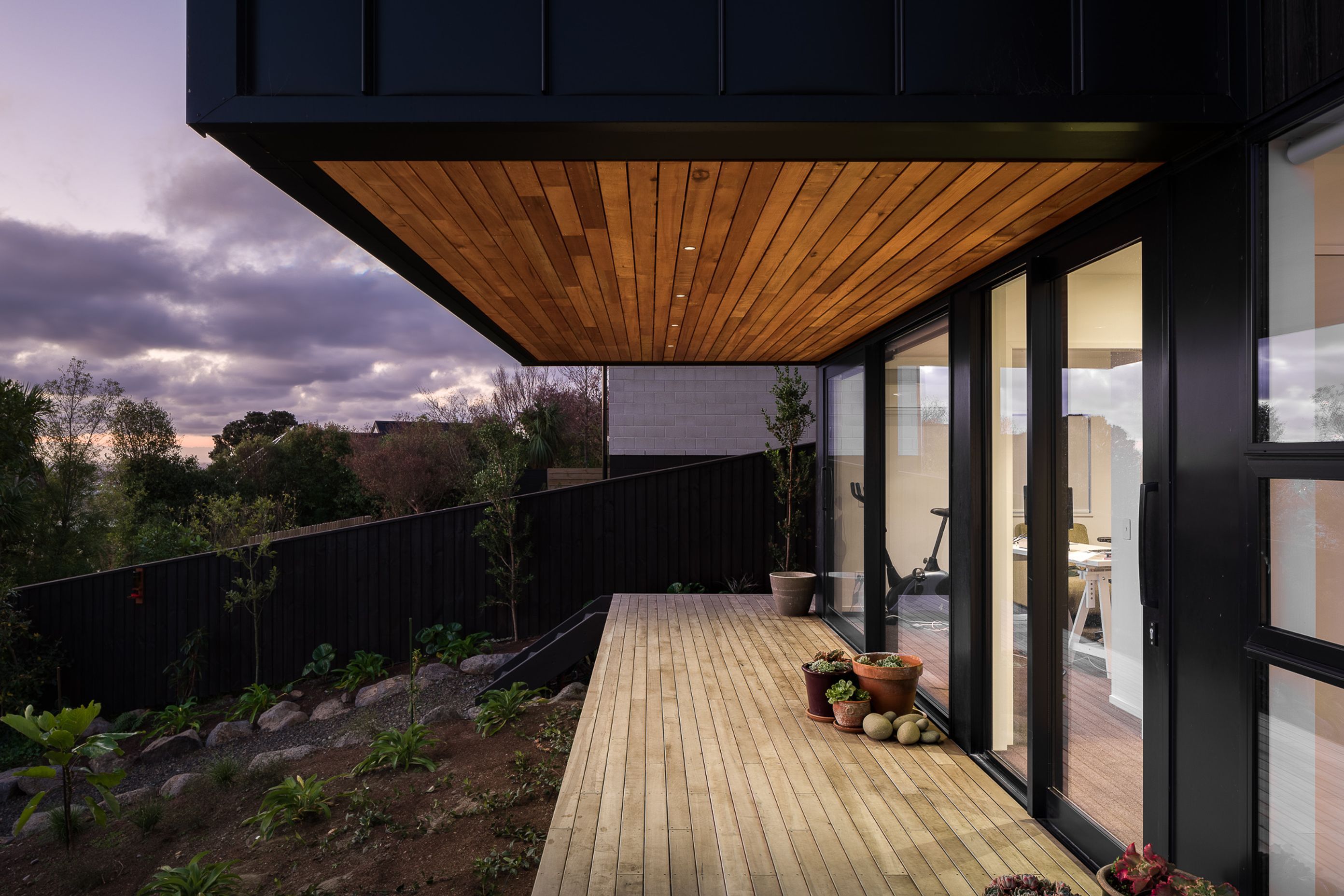 A small balcony connects the downstairs guest accommodations with the backyard.