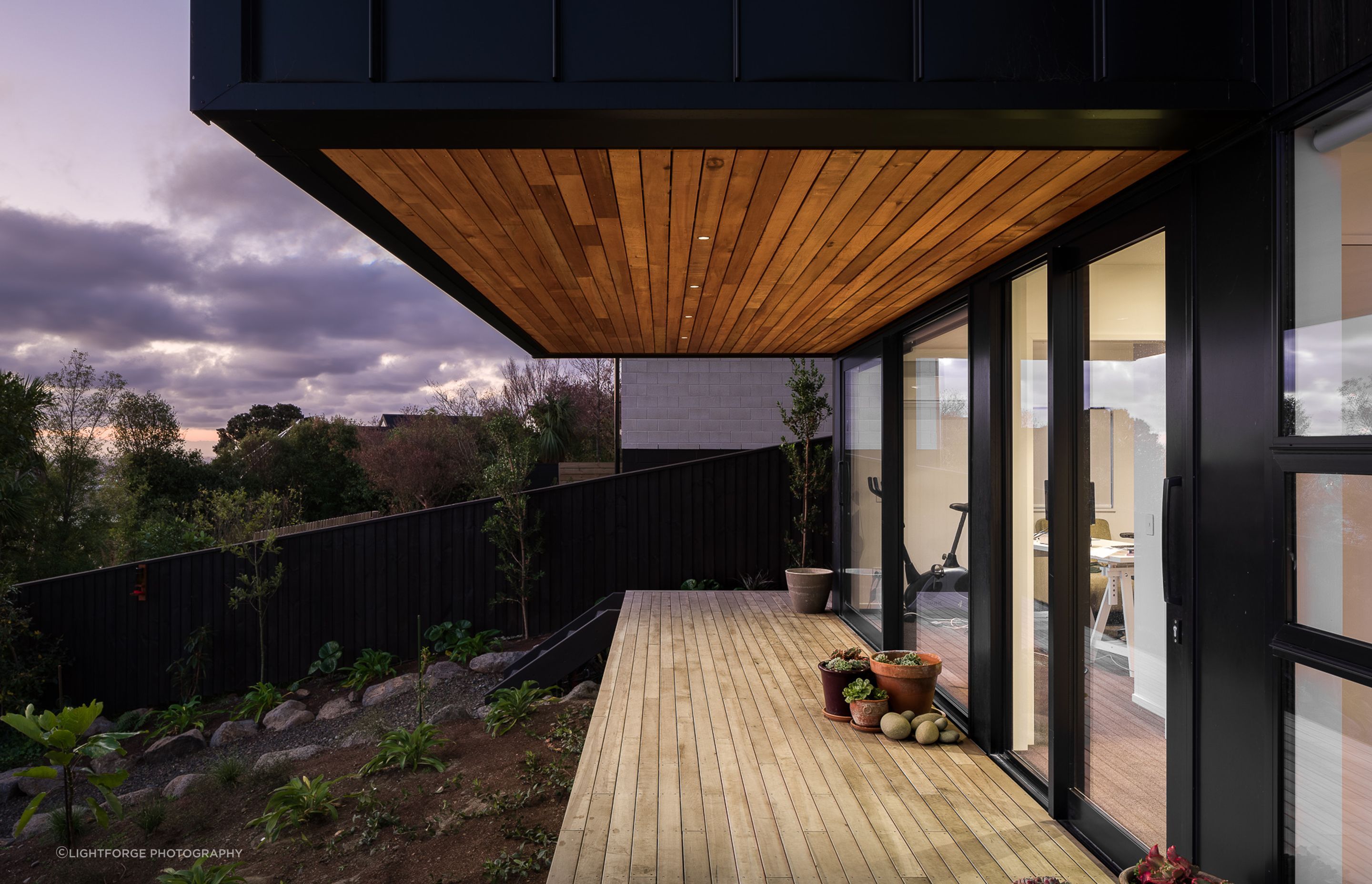 A small balcony connects the downstairs guest accommodations with the backyard.