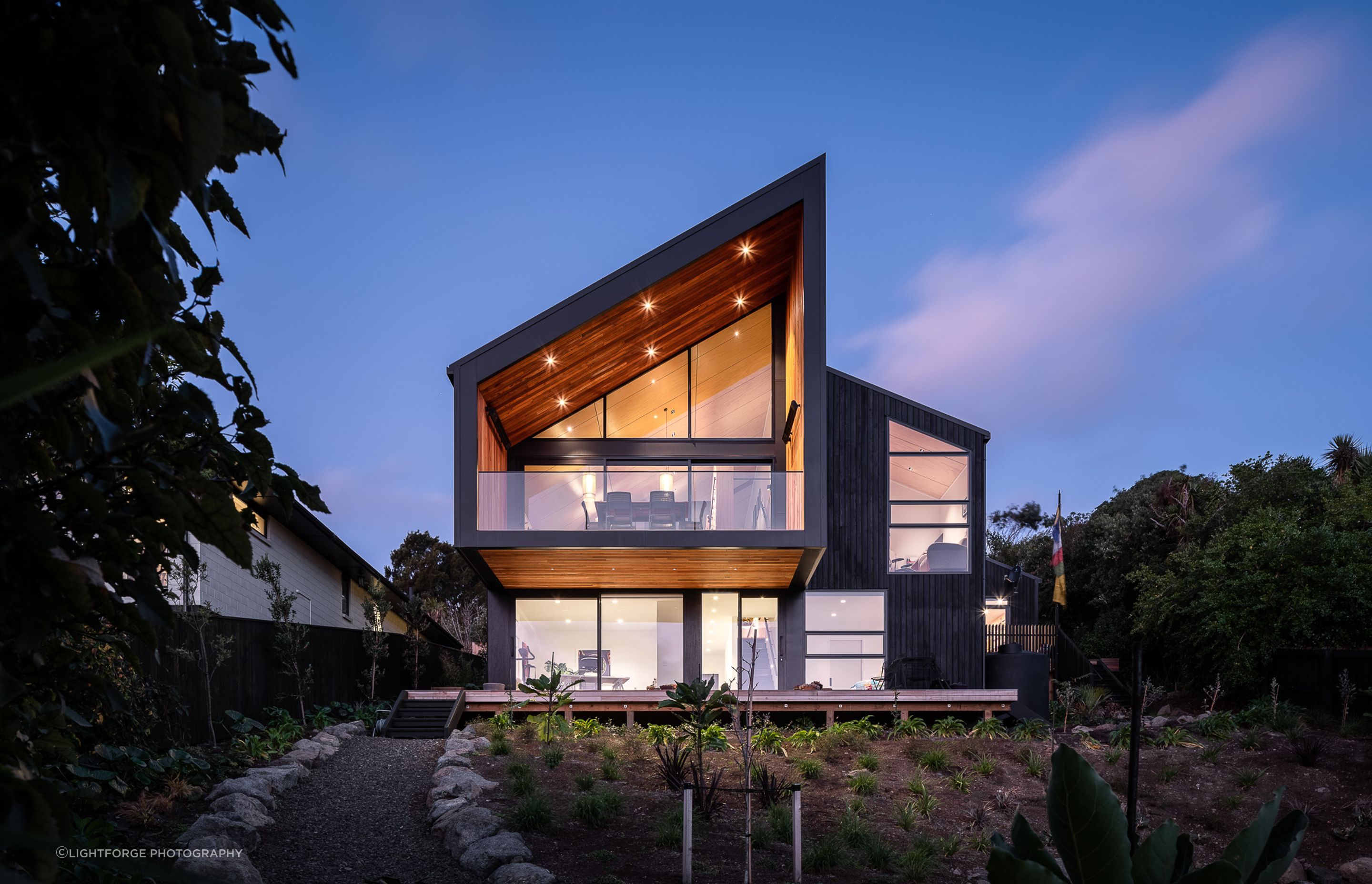 Arranged over two floors, the home comprises a main floor level, which houses an open-plan living area with mezzanine, main bedroom suite, garage and workshop. Downstairs incorporates guest accommodations.