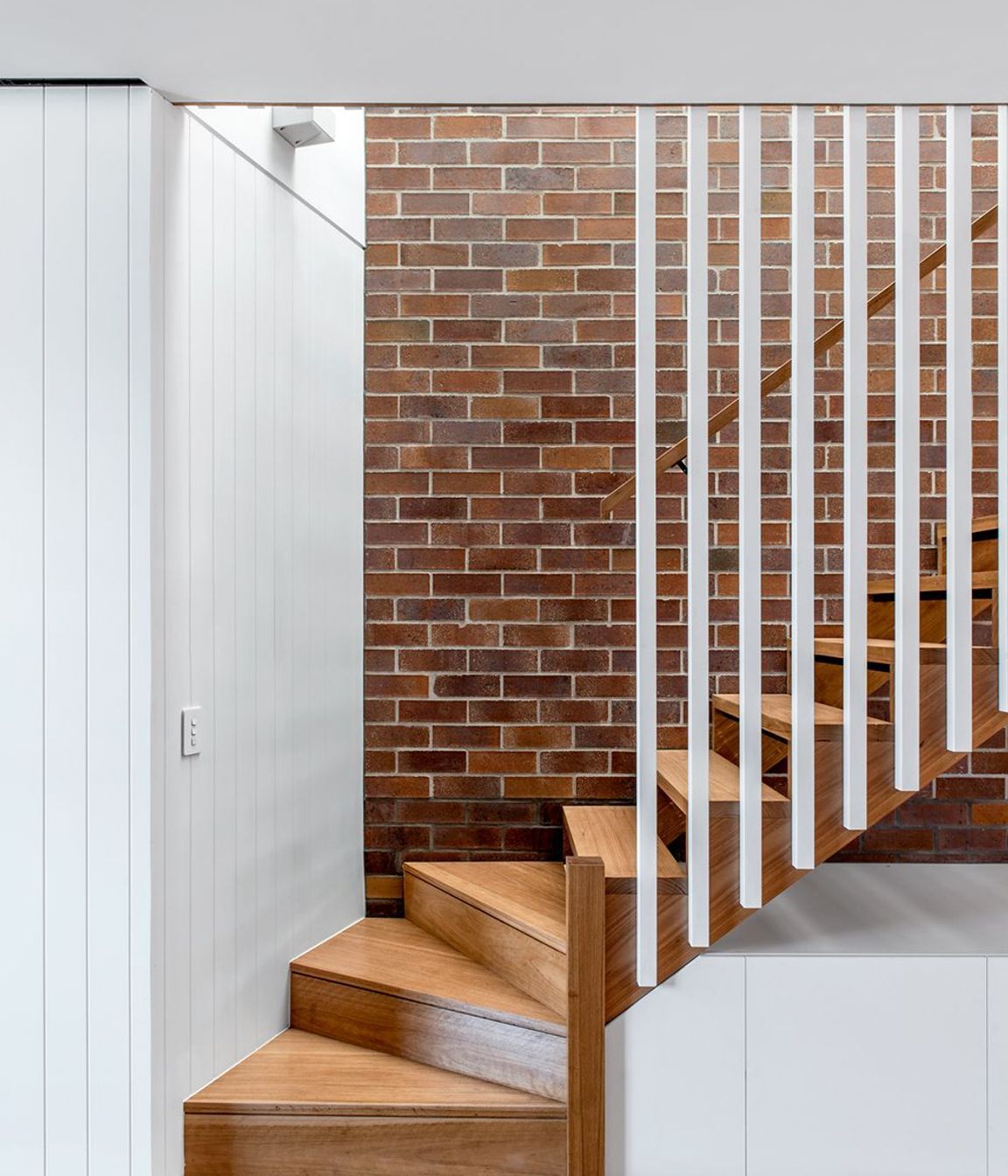 Photography: Cathy Schusler | Combining solid and lightweight construction, the three new dwellings mesh the qualities of the traditional terrace house with those of the Queenslander. Locally sourced face brick are used in Party walls, with floors and ext