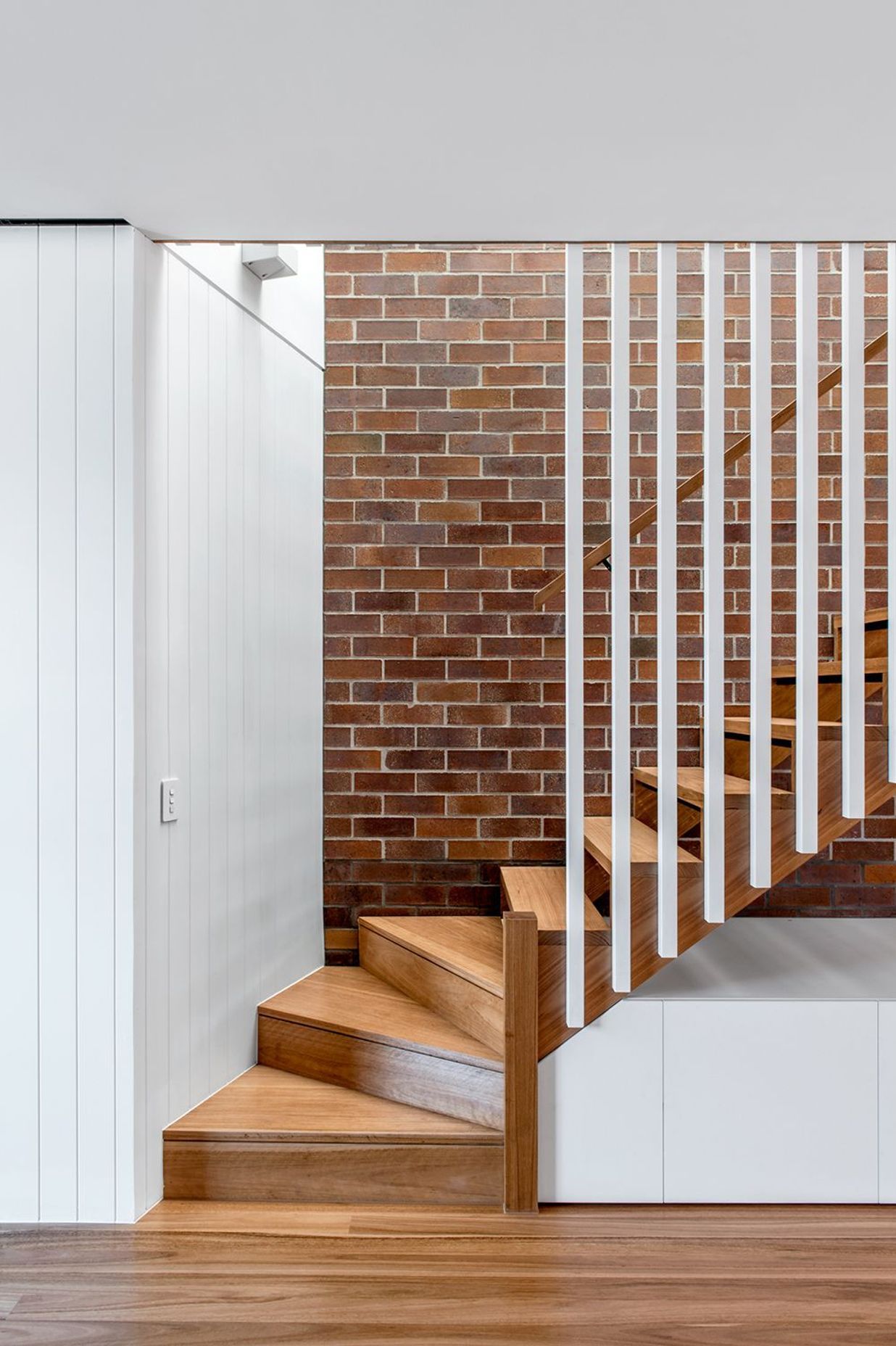 Photography: Cathy Schusler | Combining solid and lightweight construction, the three new dwellings mesh the qualities of the traditional terrace house with those of the Queenslander. Locally sourced face brick are used in Party walls, with floors and ext