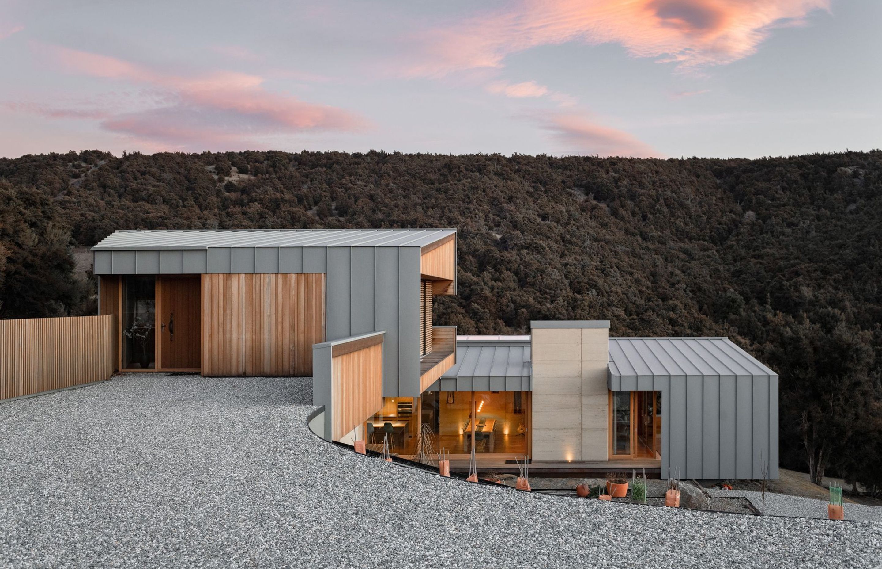 The placement of the home follows the natural contour of the site, which slopes away to the south. Access to the home is via the first of three interconnected forms which descend across five half-levels.